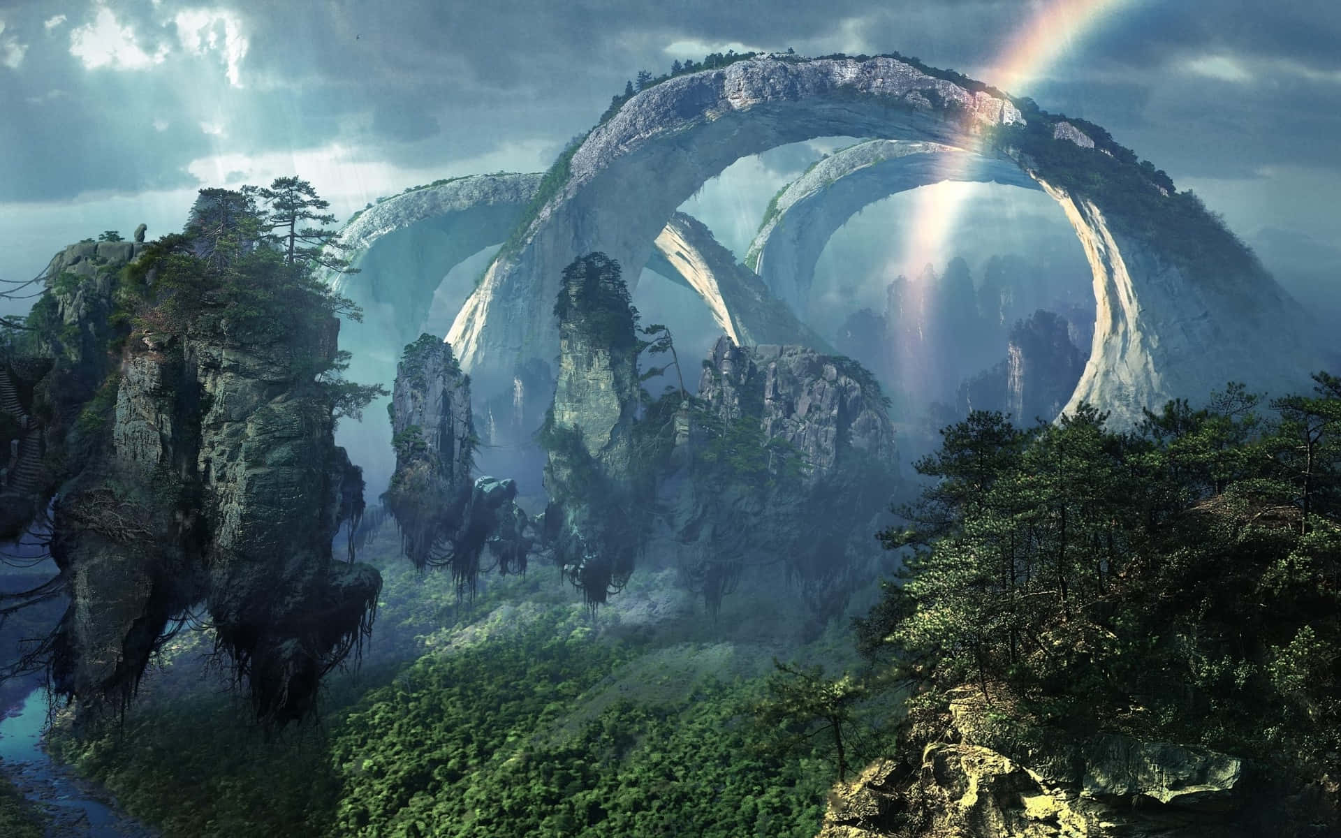 Avatar Pandora 桌布 壁紙 — 一個雄偉的奇幻景觀，巨大的天然石拱門從霧氣瀰漫的森林中升起，上方雲層中有一道鮮豔的彩虹劃過。