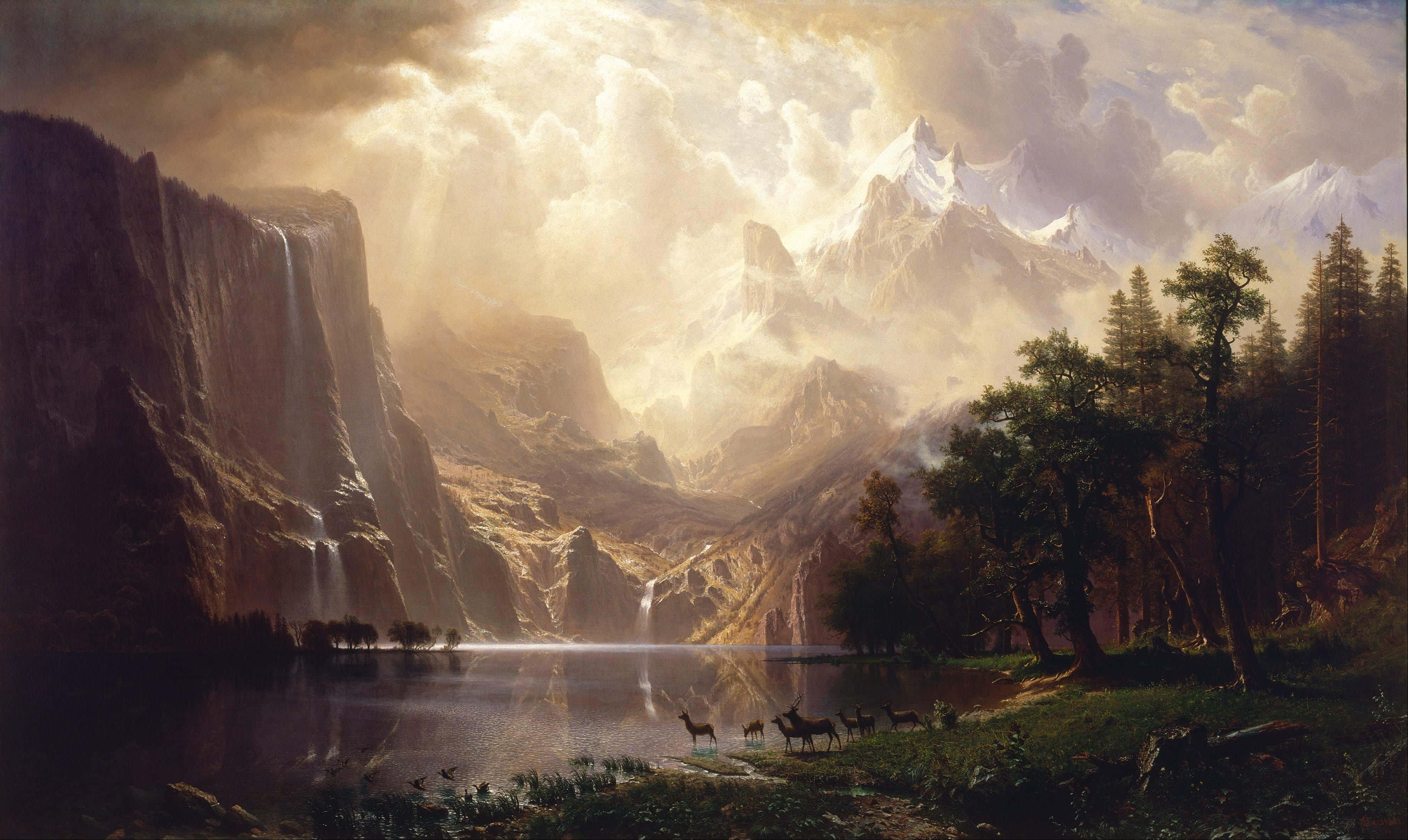 Romanticism 桌布 壁紙 — 一個雄偉的山谷，有白雪覆蓋的山峰、層疊的瀑布，以及鹿在平靜的湖邊吃草，沐浴在戲劇性的金色陽光下。