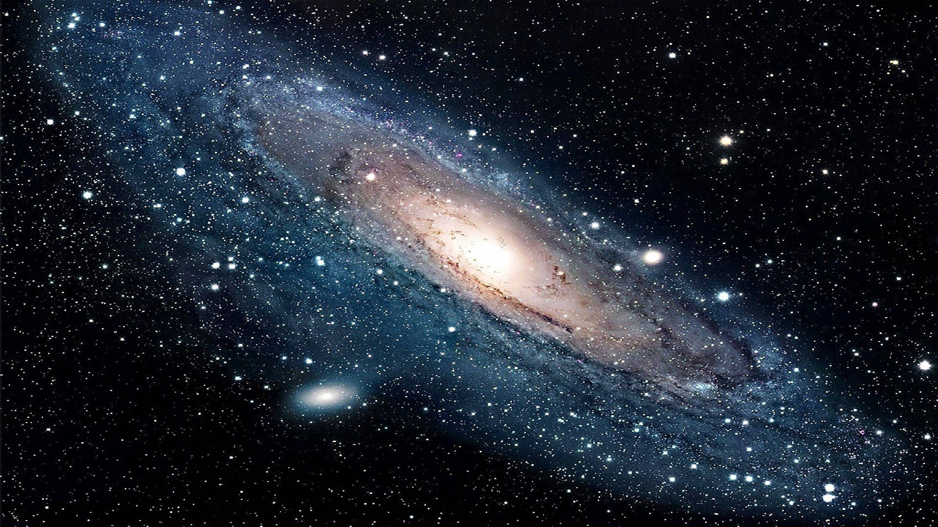 Space Pc 桌布 壁紙 — 一個雄偉的螺旋星系，在佈滿星辰的宇宙虛空中，閃耀著藍色和金色的漩渦臂。