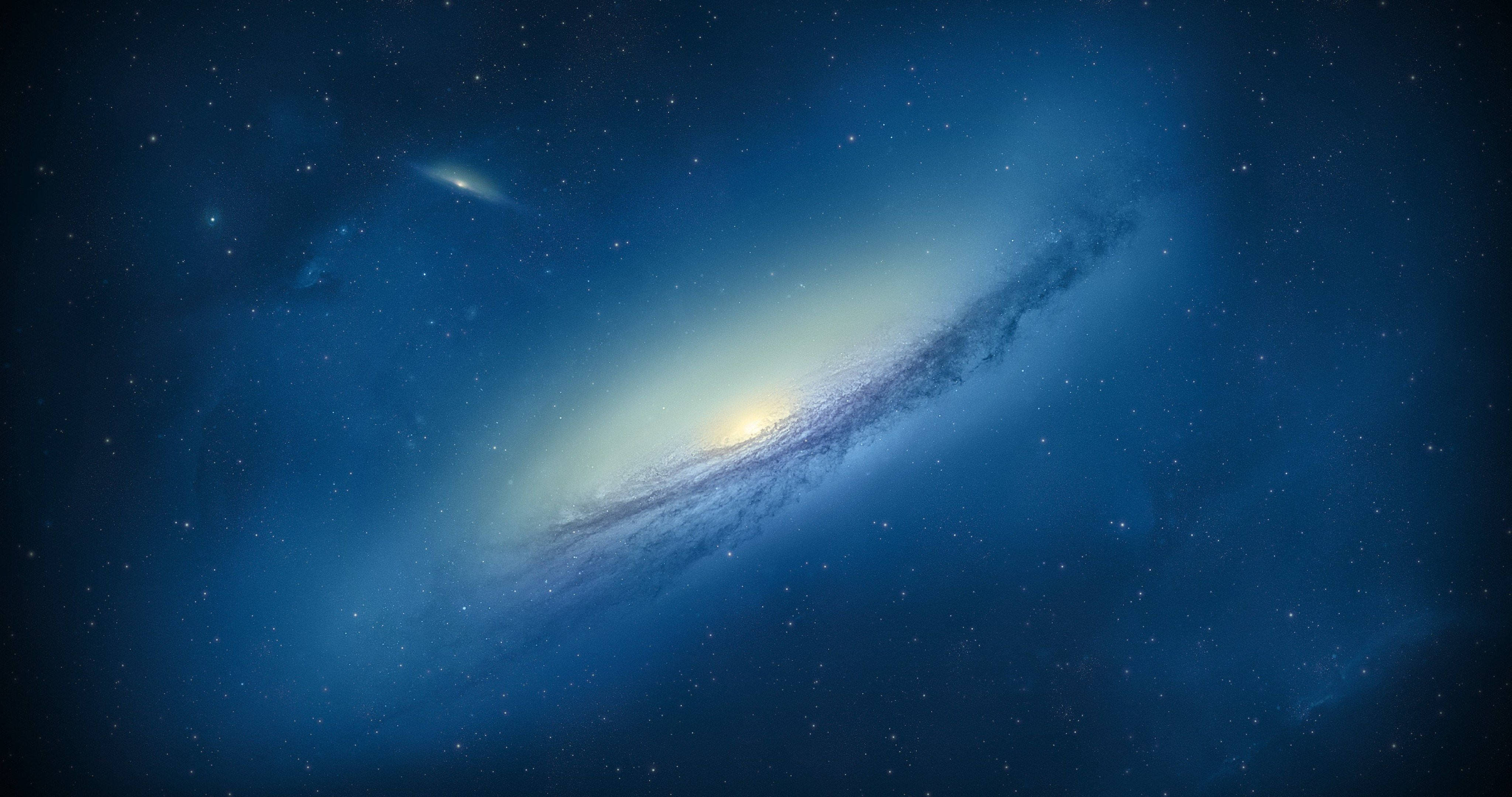 4K ultra HD galaxy 桌布 壁紙 — 一個雄偉的螺旋星系在深藍色星空中閃耀著明亮的核心和旋轉的旋臂。