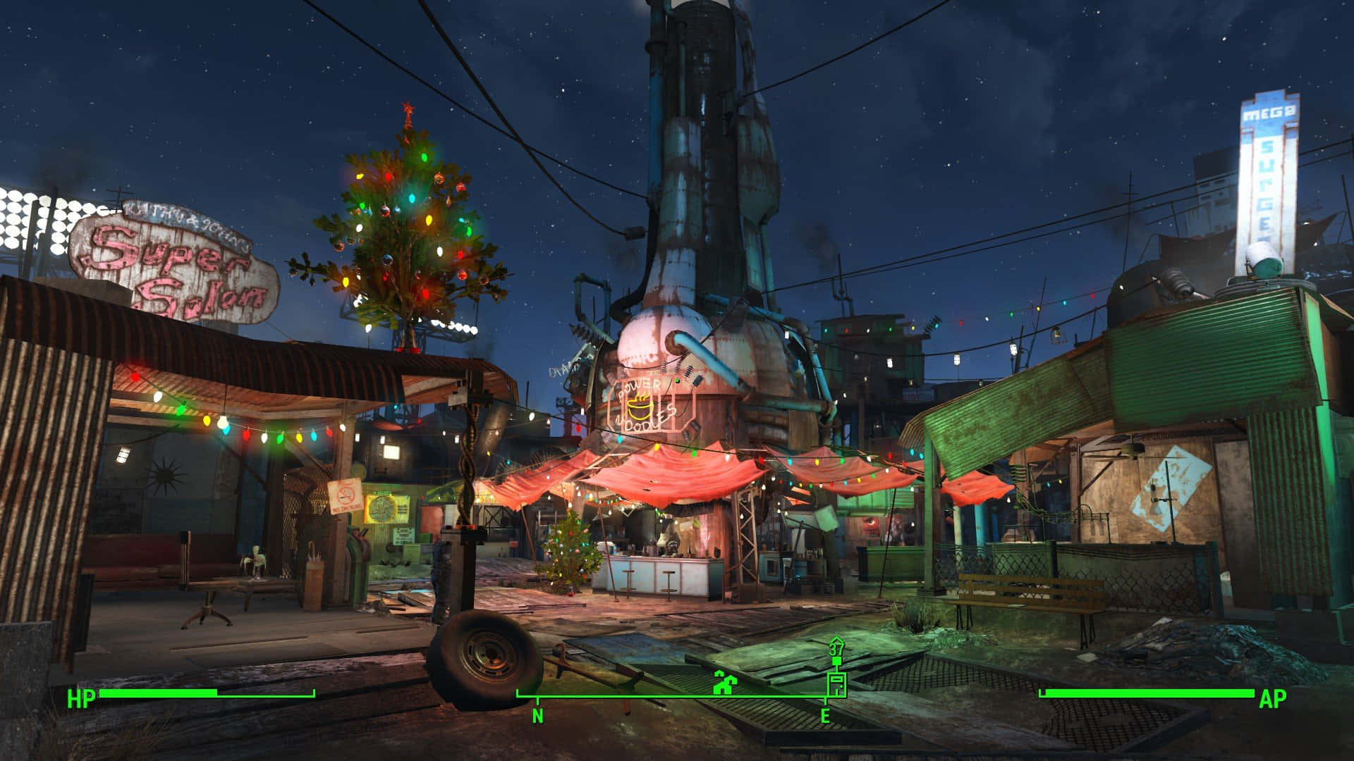 Diamond City 桌布 壁紙 — 一個霓虹燈照亮的末世小鎮廣場夜晚，有一個裝飾過的聖誕樹在星空下發光。