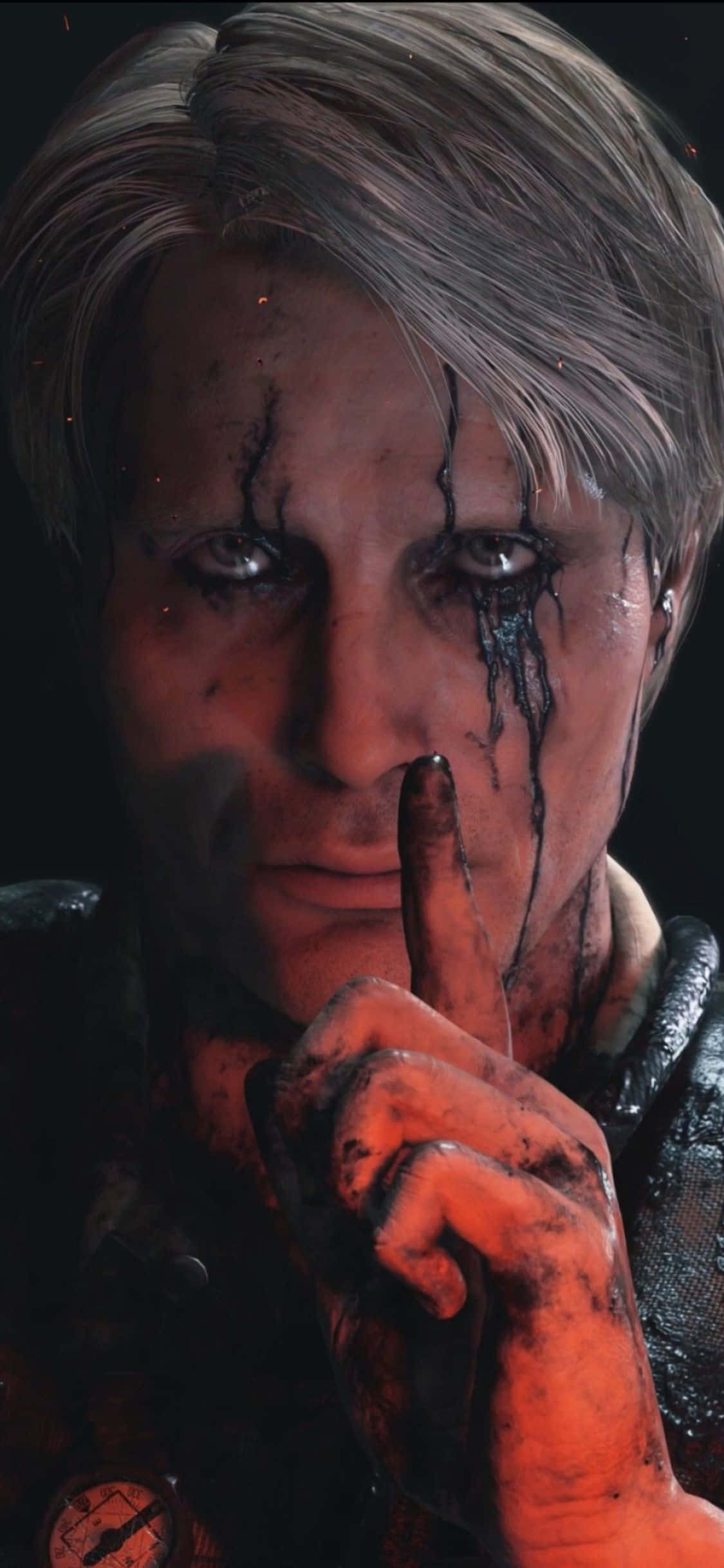 iPhone X Death Stranding 桌布 壁紙 — 一個面容陰沉、臉上帶有血痕的男人，在黑暗背景前豎起一根手指，做出無聲警告。