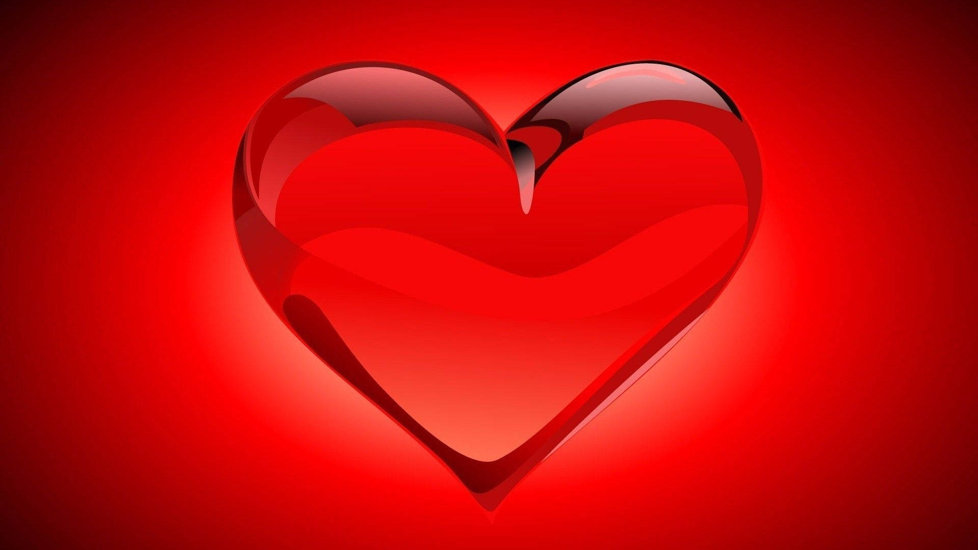 Love Heart 桌布 壁紙 — 一個頂部破裂的光澤紅心在紅色漸變背景上發光。