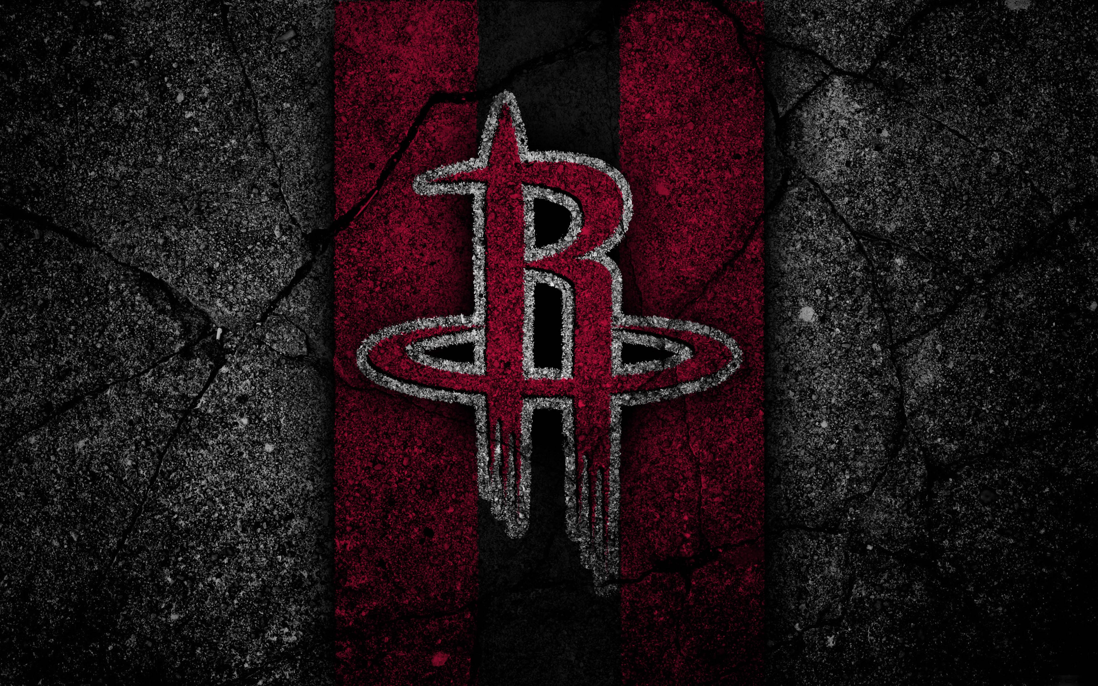 Houston Rockets 桌布 壁紙 — 一個風化的休士頓火箭隊標誌，以紅色和黑色大膽地矗立在龜裂的混凝土牆上，帶有粗糙的紋理。