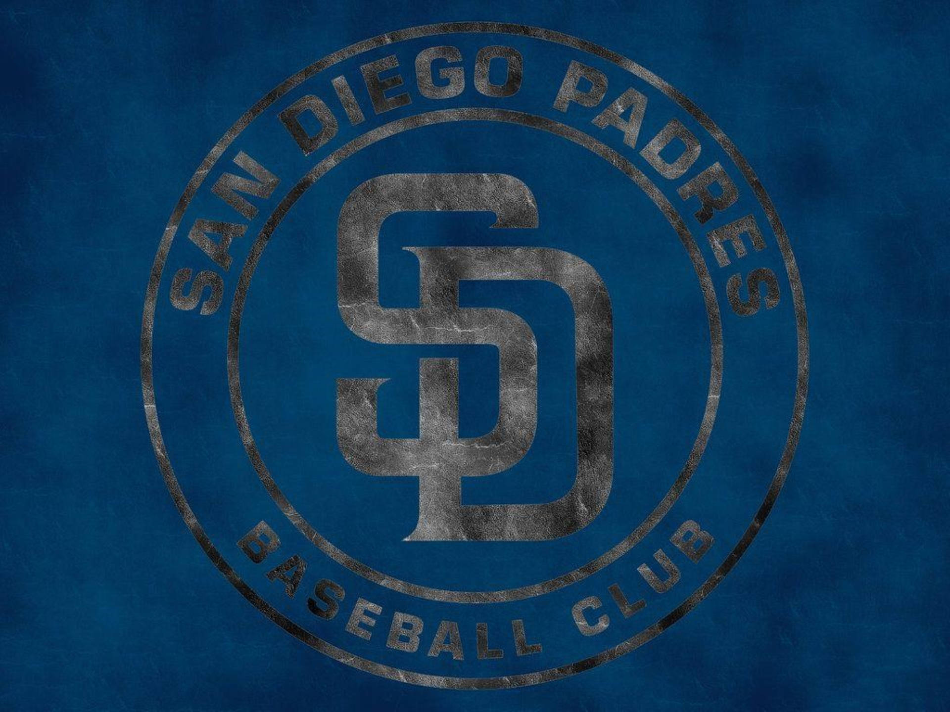 Padres 桌布 壁紙 — 一個風化的聖地牙哥教士棒球會標誌，以金屬灰色呈現，背景為有紋理的藍色。