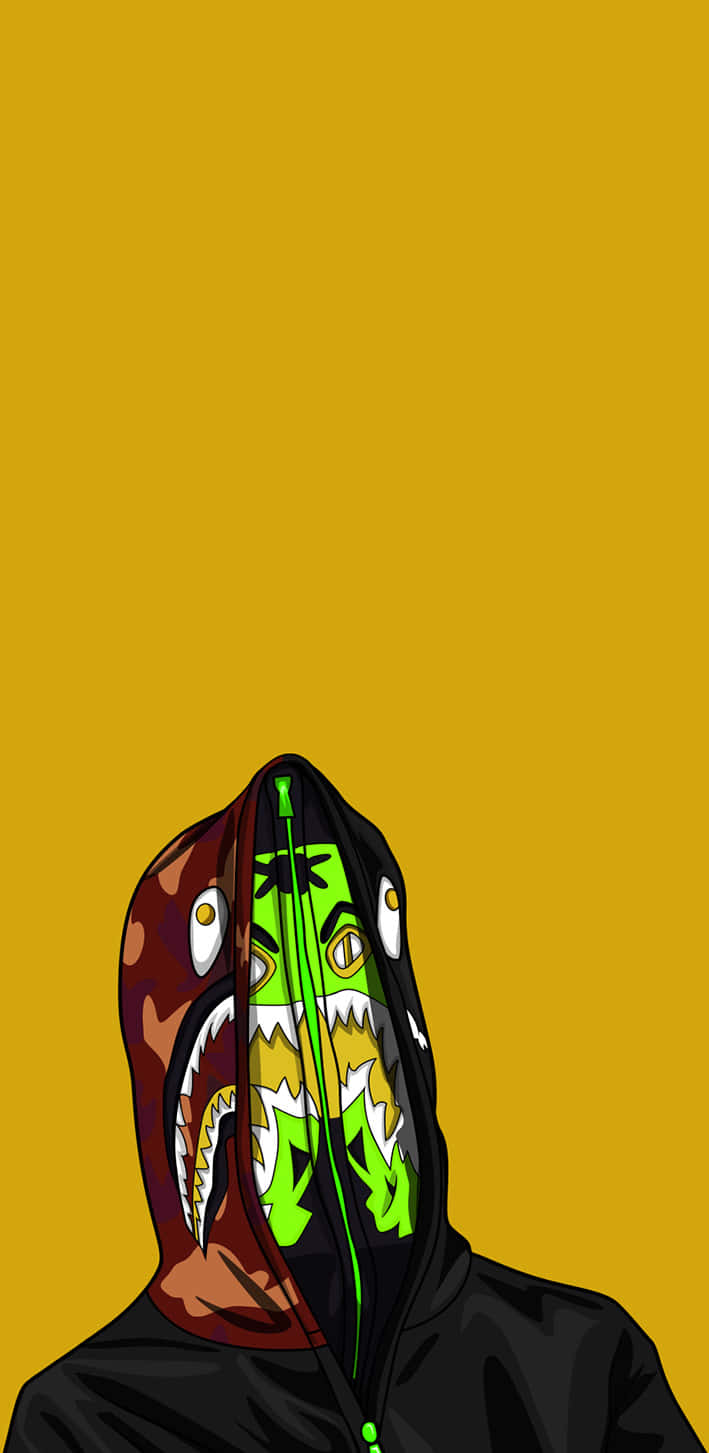 Bape iPhone 桌布 壁紙 — 一個風格化的人物穿著黑色連帽衫，帶有分裂的鯊魚頭設計，在純芥末黃色背景上露出綠色和棕色的下顎。