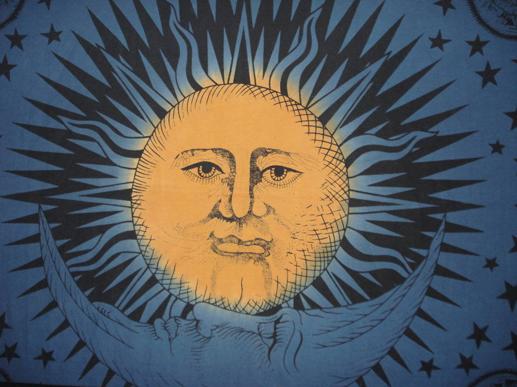 Sun And Moon 桌布 壁紙 — 一個風格化的太陽帶有人類面孔，從新月後面照耀在繁星點點的藍色夜空。