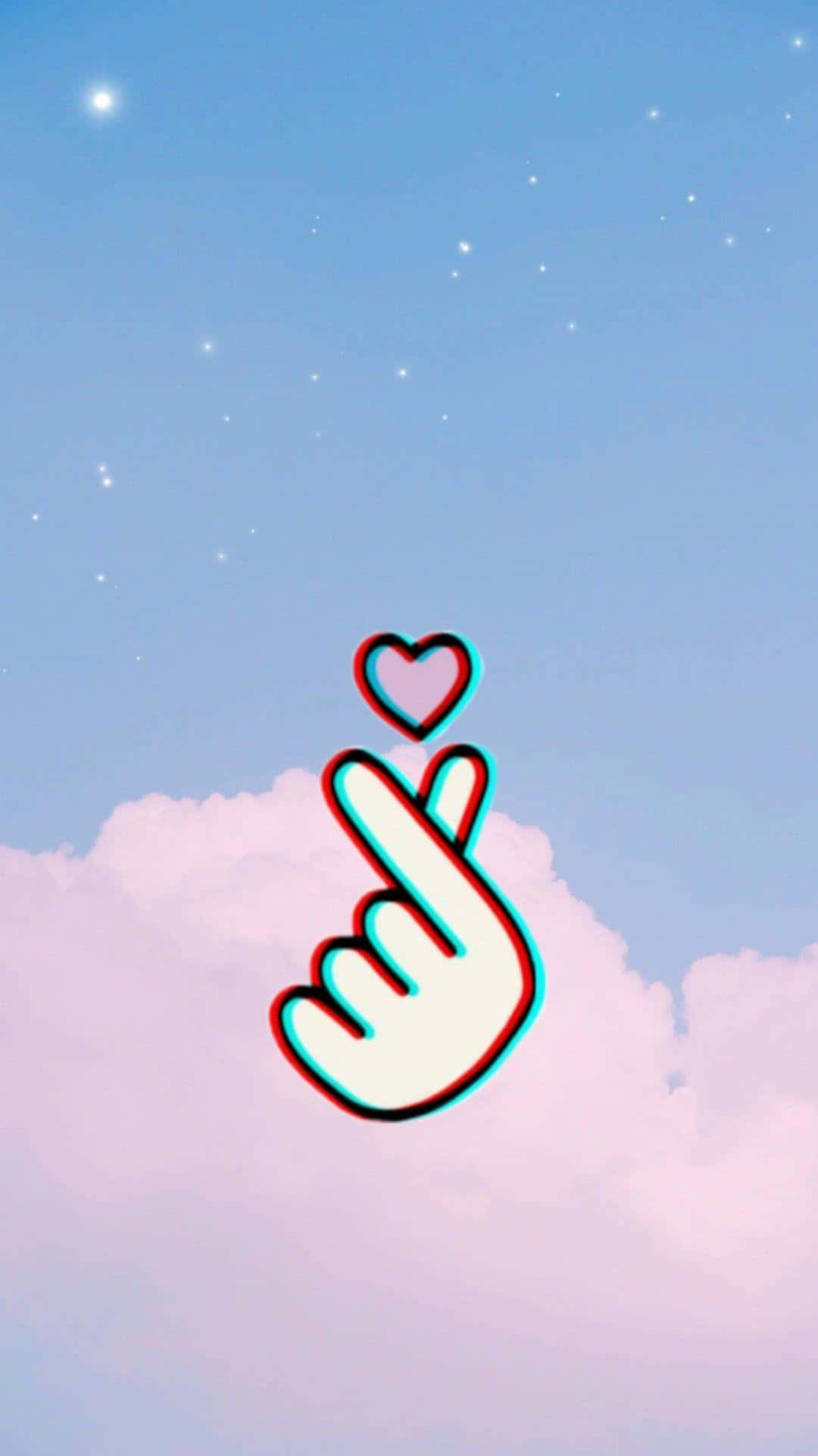 Finger Heart 桌布 壁紙 — 一個風格化的手勢，上方有一顆心，漂浮在柔和的雲朵和閃爍星星的粉彩天空上。