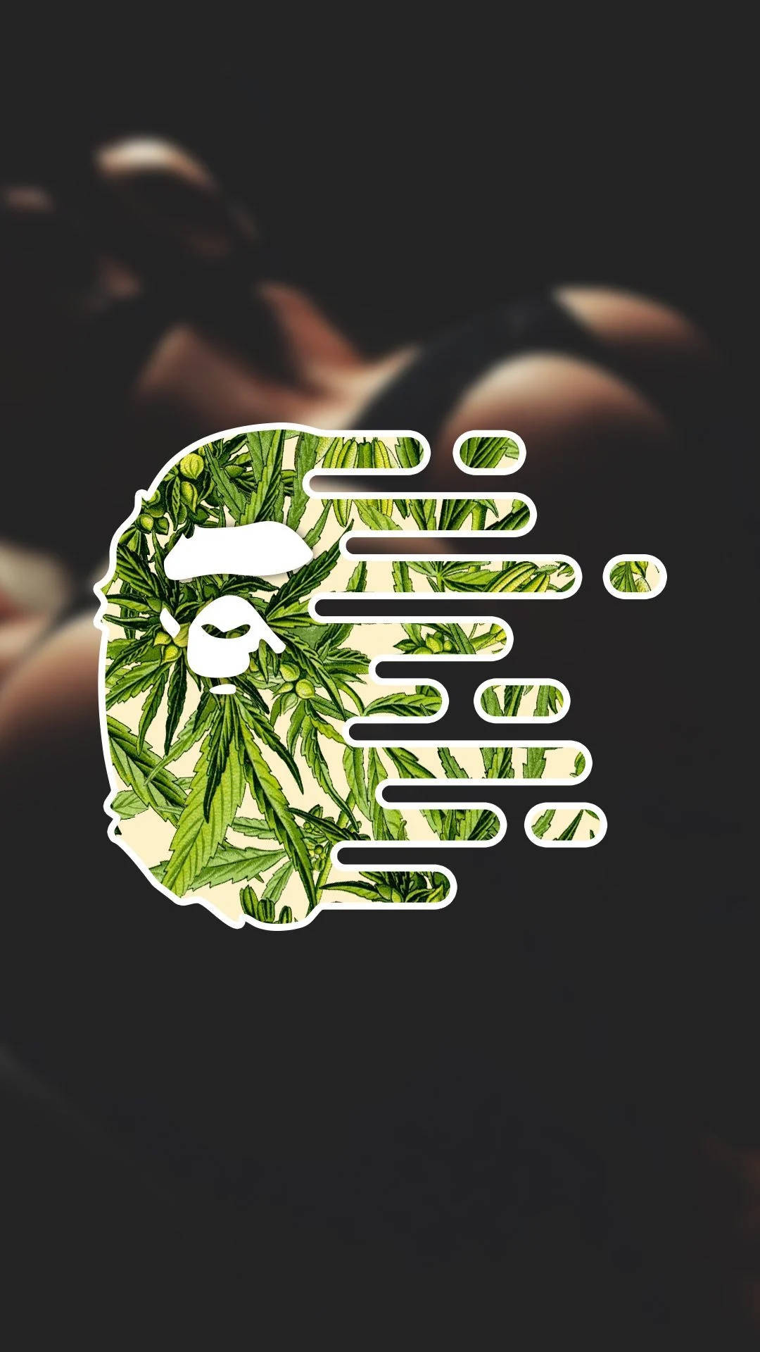 BAPE 標誌 桌布 壁紙 — 一個風格化的猿頭標誌，充滿大麻葉，背景模糊黑暗。