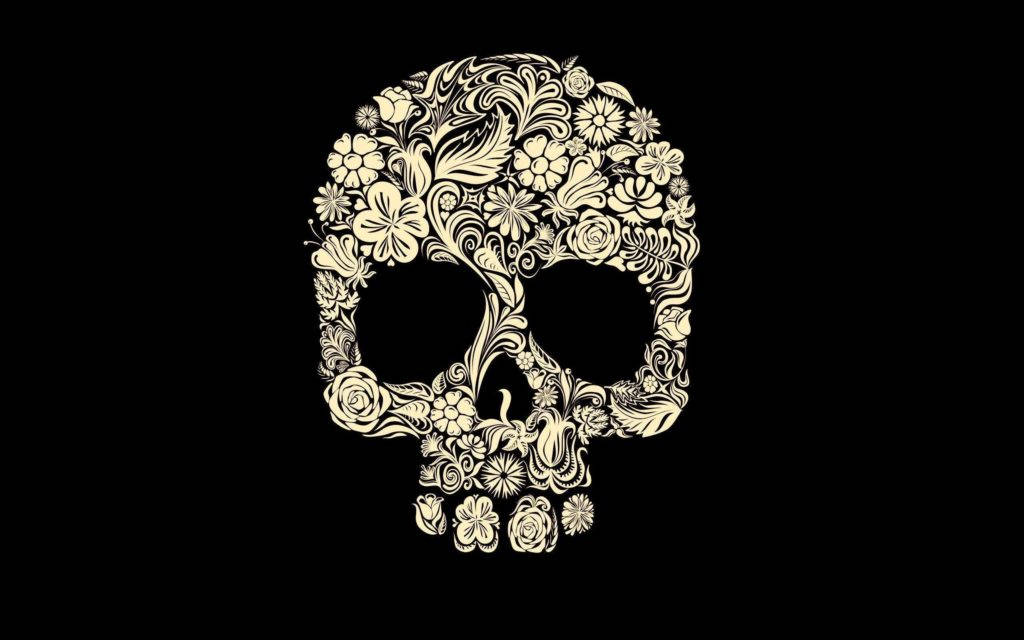 HD Skull 桌布 壁紙 — 一個風格化的頭骨，在純黑色背景上精緻地點綴著奶油色的花卉圖案。