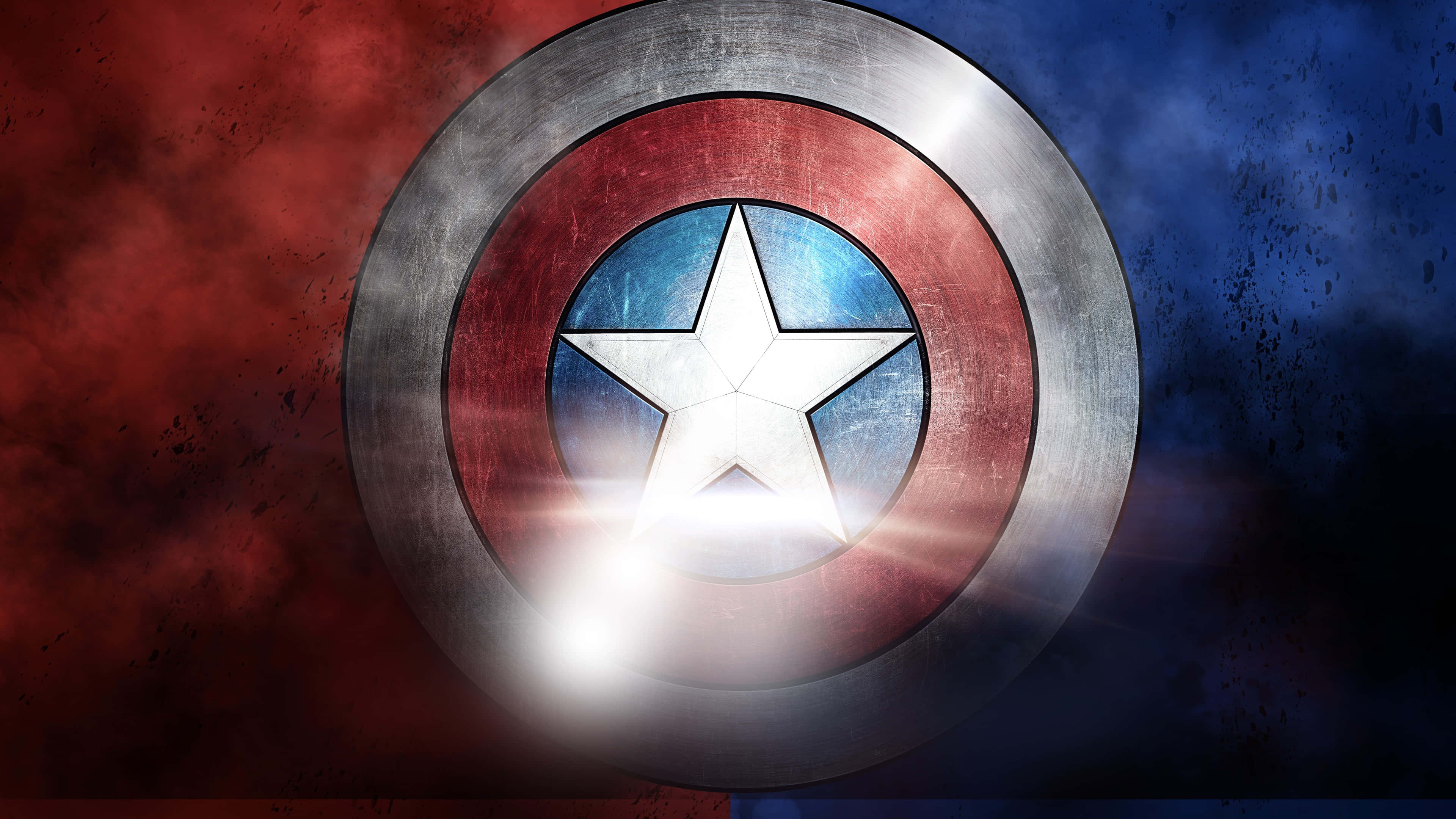 Captain America Desktop 桌布 壁紙 — 一個飽經風霜的美國隊長盾牌在火紅和暴風藍的背景下發出明亮的光芒。