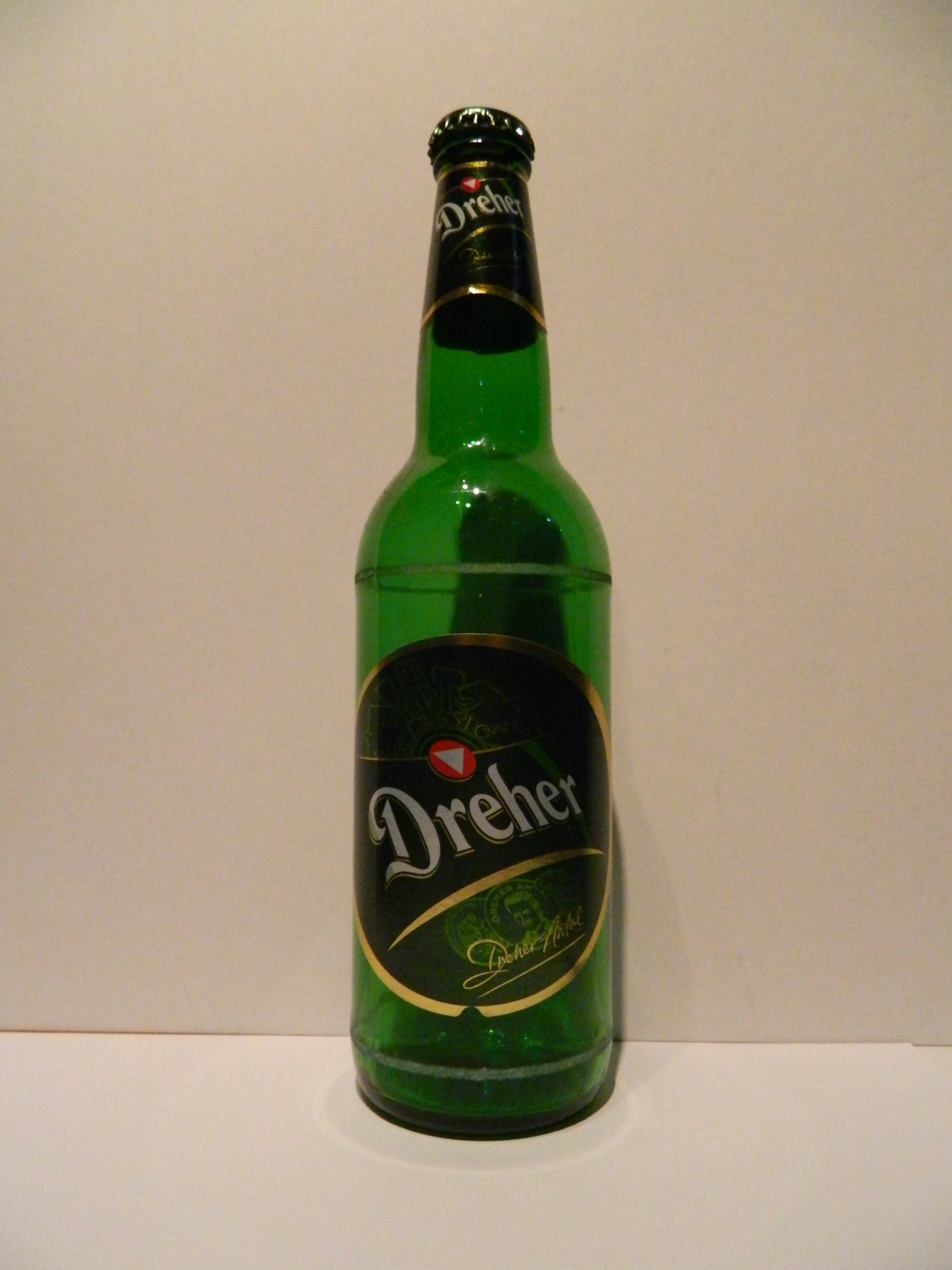 alcohol 桌布 壁紙 — 一個高大的綠色玻璃Dreher啤酒瓶直立於純米白色背景前。
