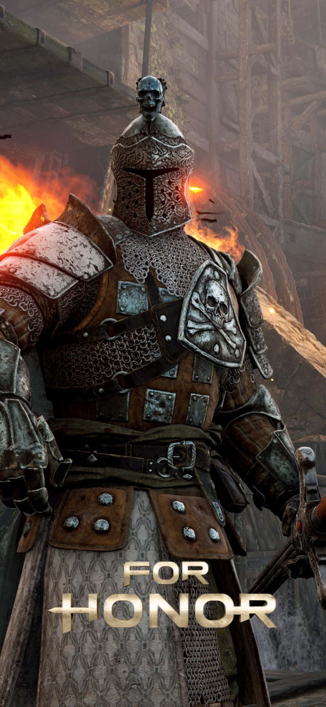 iPhone Xs For Honor 桌布 壁紙 — 一個高大的裝甲戰士，帶有骷髏圖案，站在黑暗中世紀背景的燃燒廢墟中。