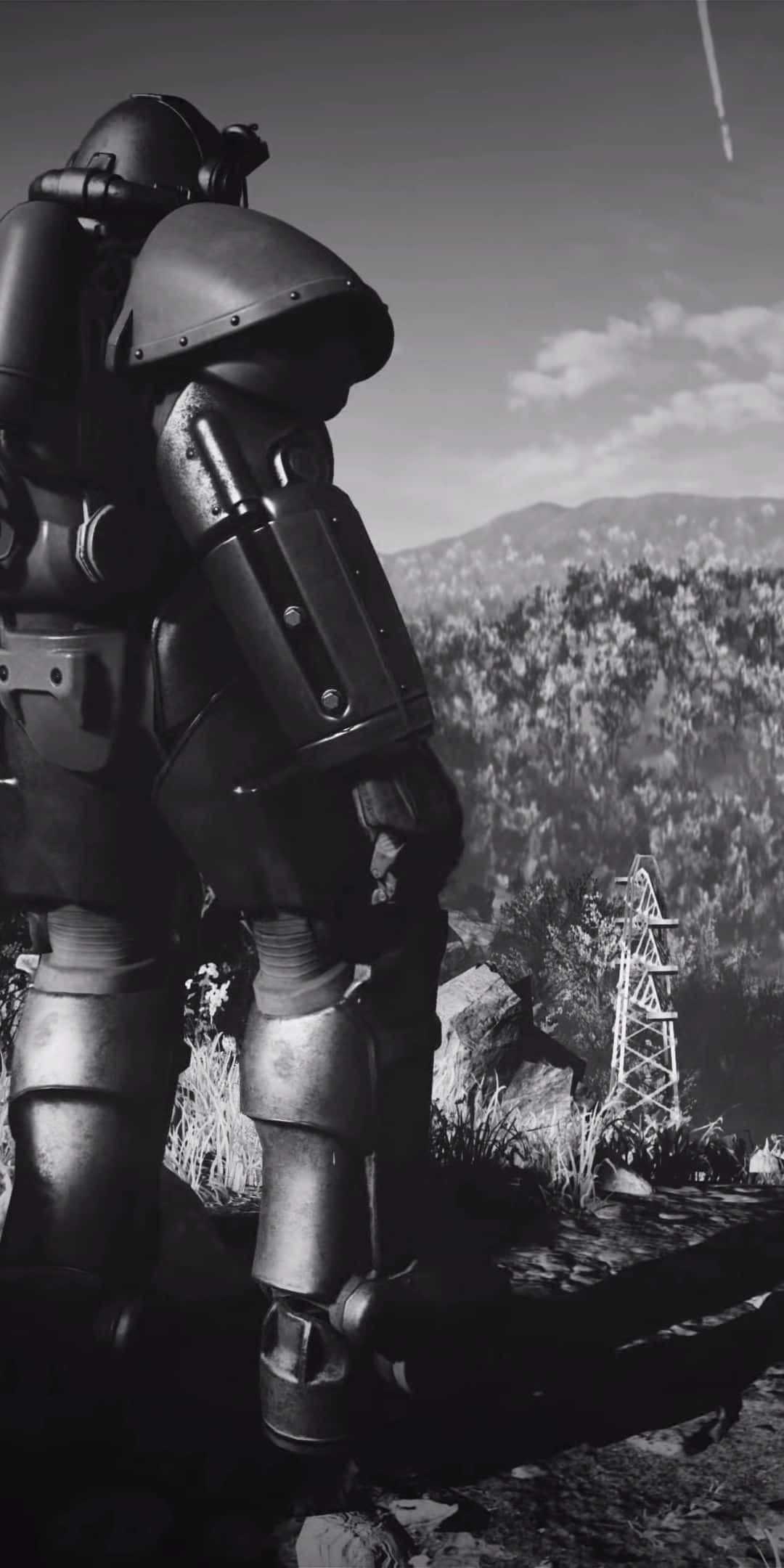Pixel 3 Fallout 76 桌布 壁紙 — 一個高聳的裝甲人物以單色調矗立在崎嶇的山景中，遠處有一座輸電塔。