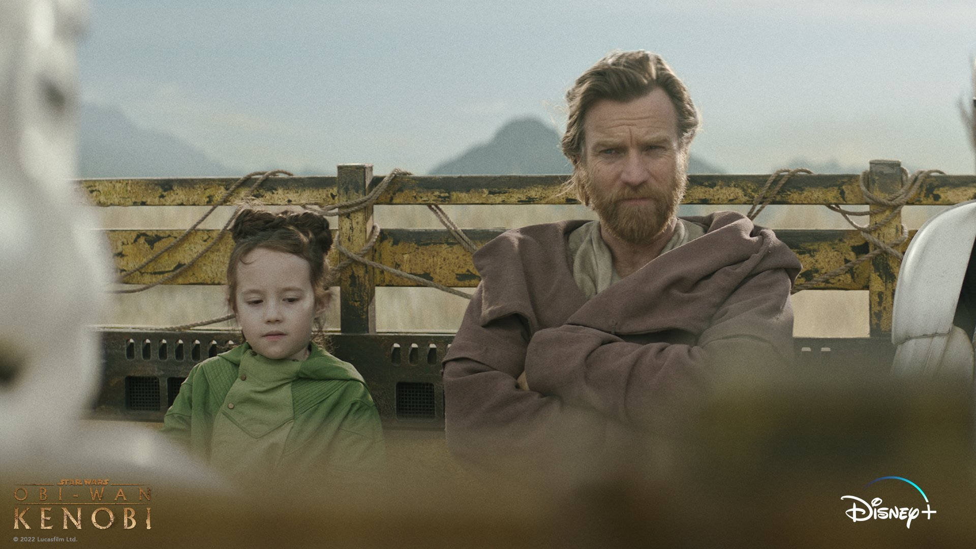 Kenobi 桌布 壁紙 — 一個鬍鬚男人和一個年輕女孩莊嚴地坐在一張風化的長椅上，遠方山巒朦朧。