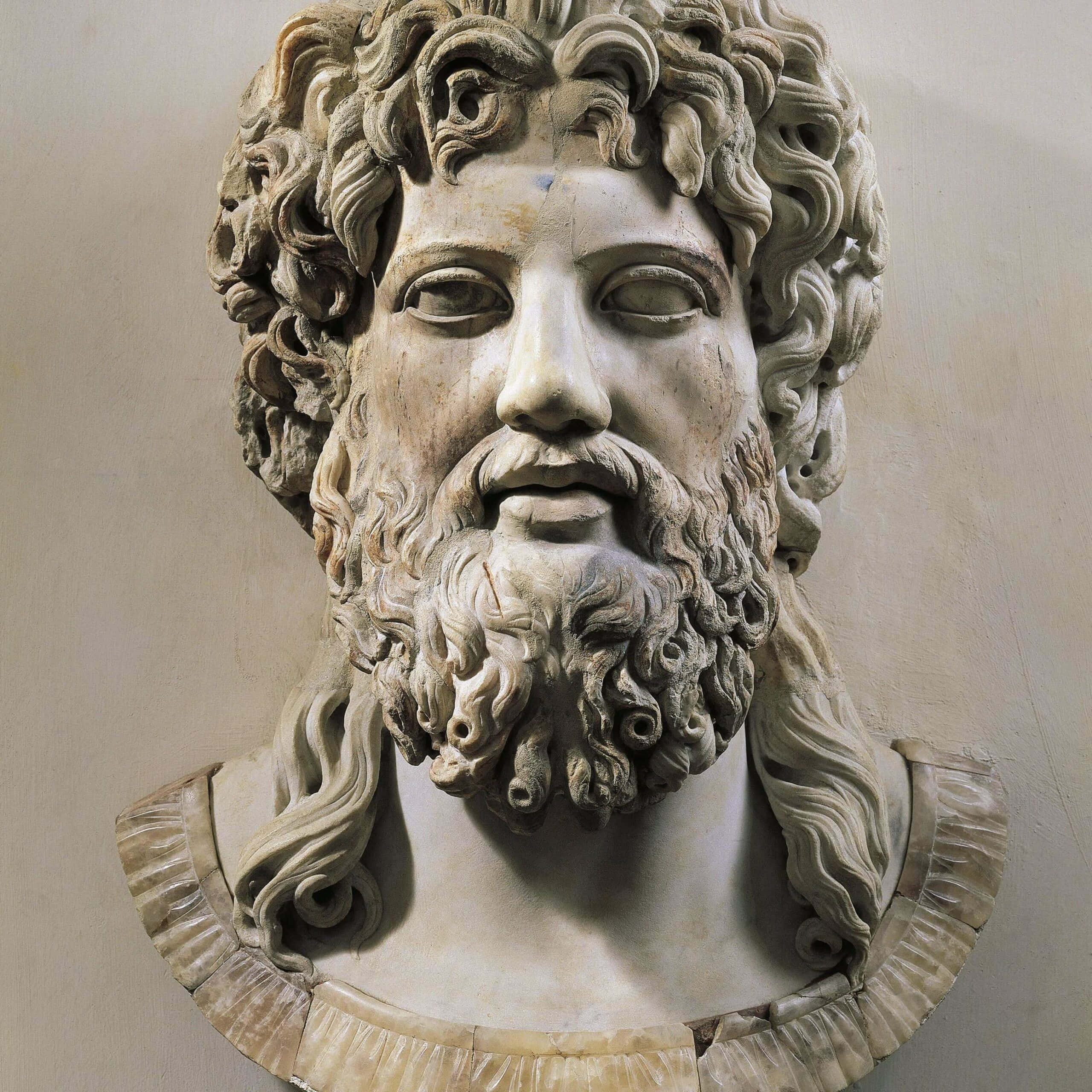 greek 桌布 壁紙 — 一個鬍鬚男子的風化大理石半身像，有捲髮和平靜的表情，由垂褶領圍繞。
