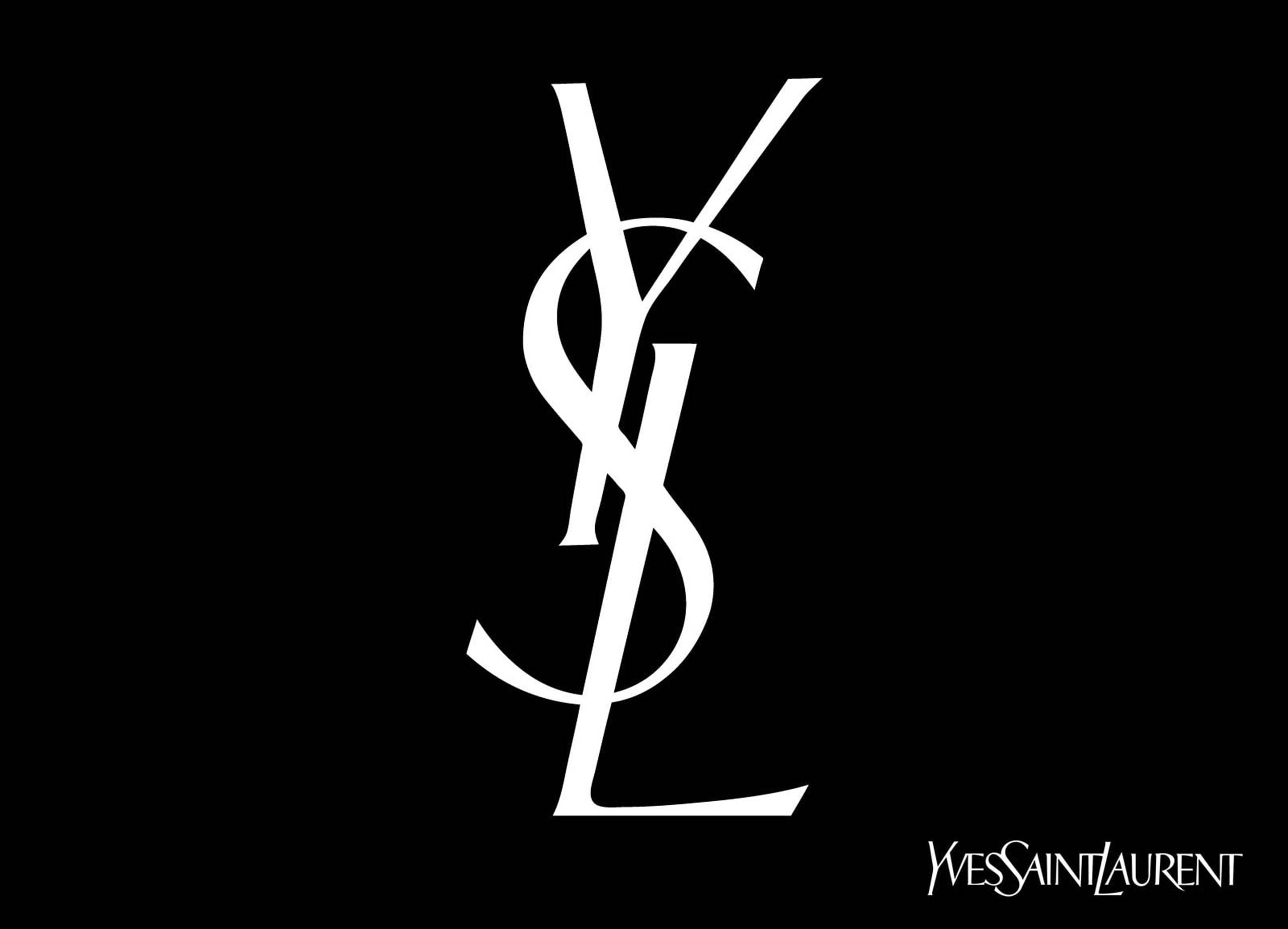 Ysl 桌布 壁紙 — 一個鮮明的白色YSL字母組合標誌，居中於純黑色背景上，角落有較小的文字。