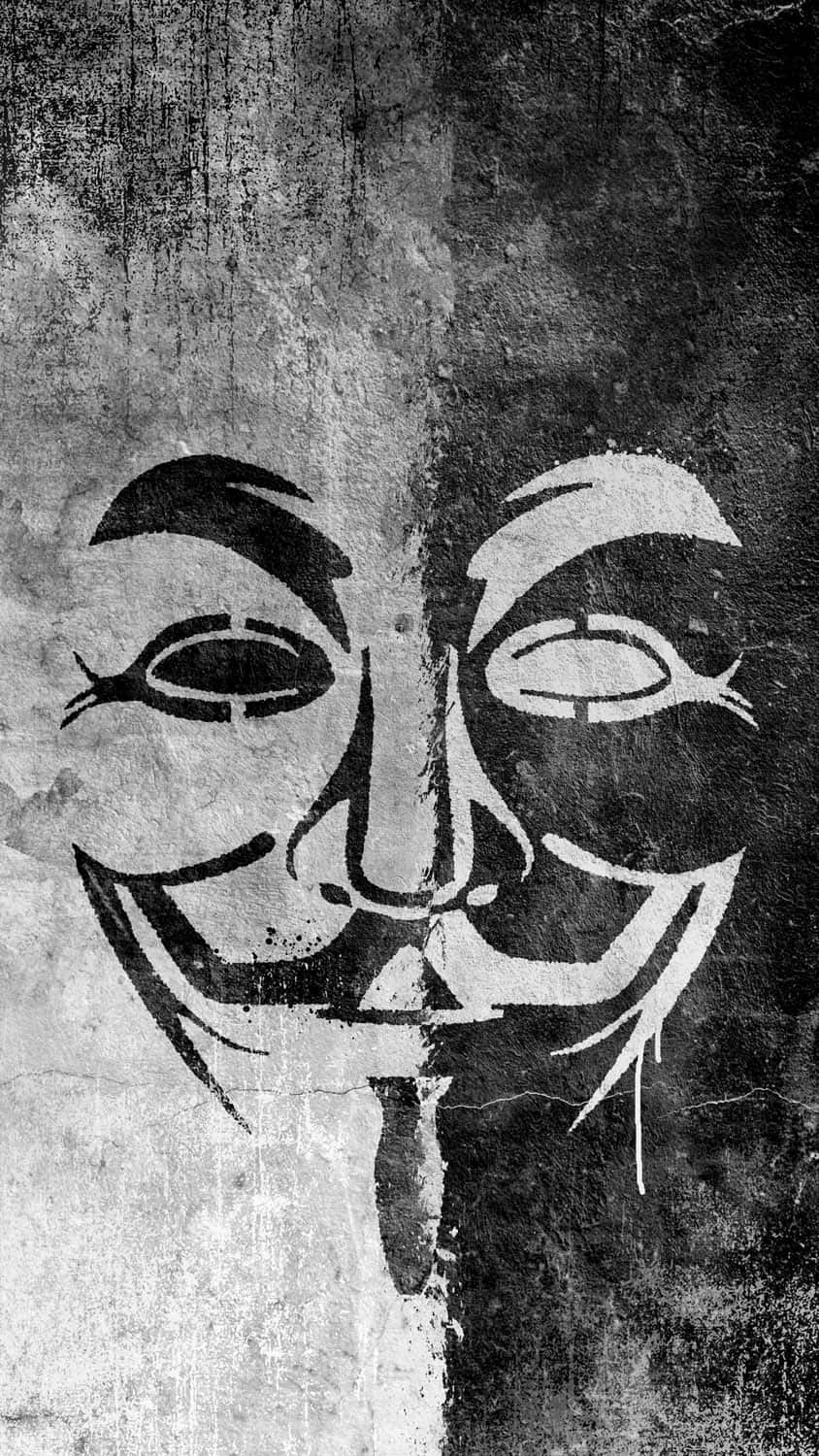 Anonymous iPhone 桌布 壁紙 — 一個鮮明的黑白塗鴉模板，描繪蓋伊·福克斯面具在風化混凝土上從中間分裂。