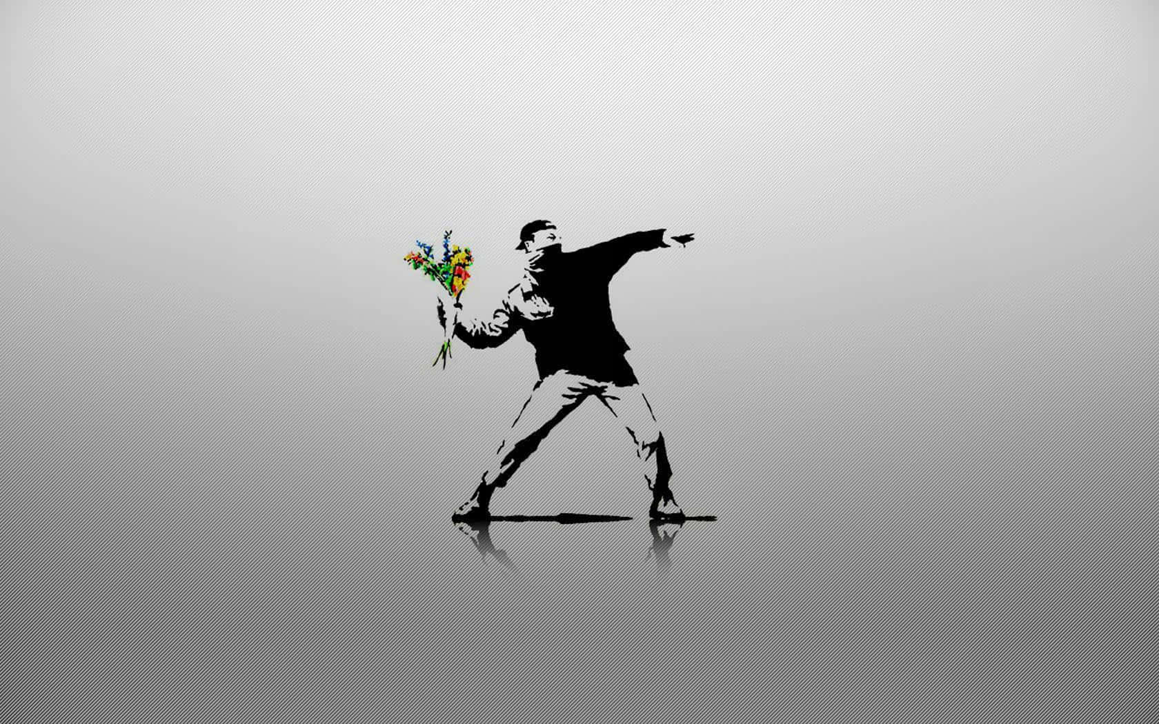 Banksy 桌布 壁紙 — 一個鮮明的黑色模板，描繪一個投擲姿勢的男人，手持色彩繽紛的花束，背景為漸變灰色並帶有倒影。