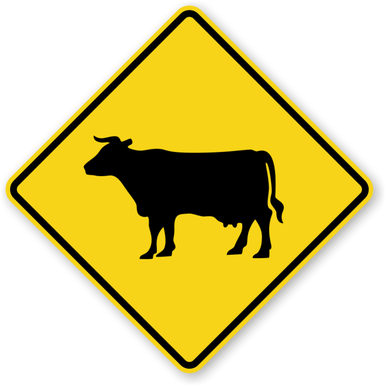 Signs 桌布 壁紙 — 一個鮮黃色菱形道路標誌，上面有黑色乳牛剪影，警告駕駛者可能有牲畜穿越馬路。