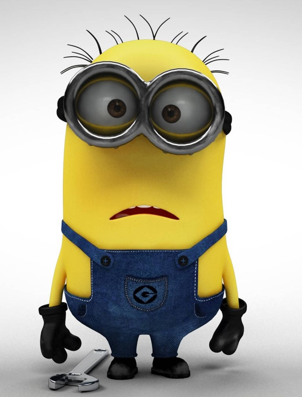 Animated 桌布 壁紙 — 一個黃色Minion戴著超大護目鏡和藍色工裝褲，在純灰色背景前拿著扳手站立。