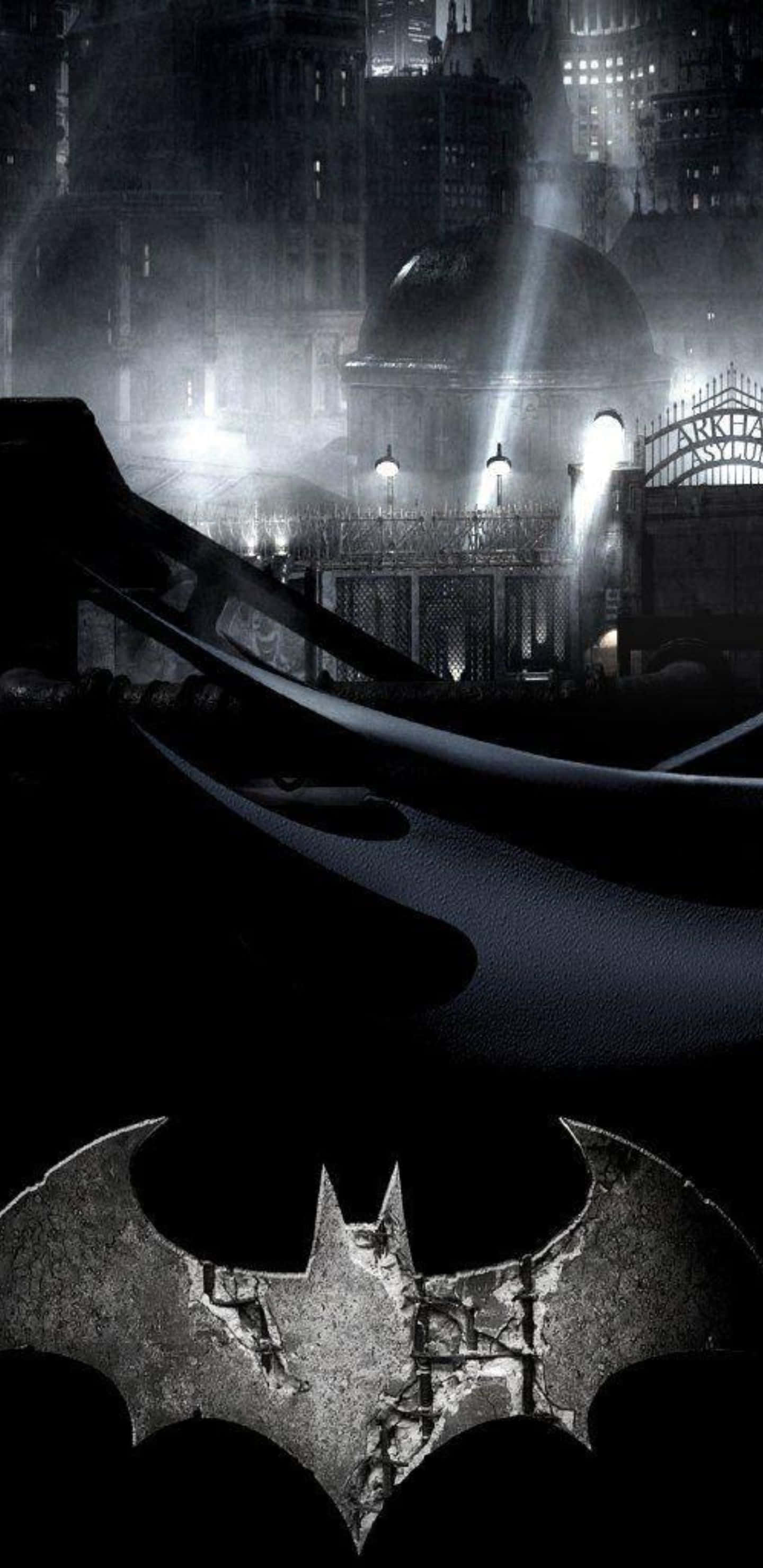Pixel 3xl Batman Arkham City 桌布 壁紙 — 一個黑暗的蝙蝠標誌停留在裂開的人行道上，下方是陰森街燈照亮、高聳的哥德式城市景觀。
