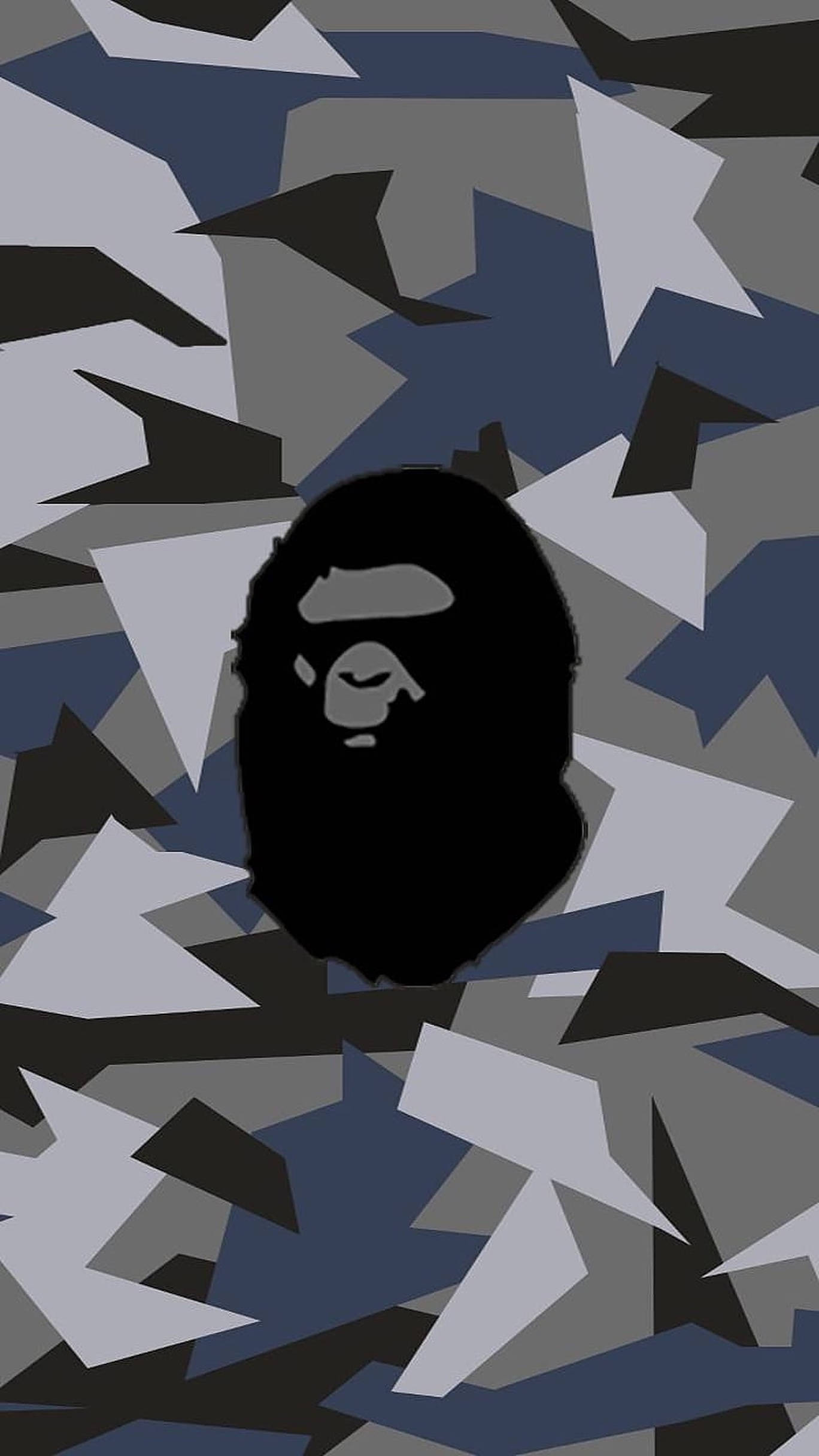 bape logo 桌布 壁紙 — 一個黑色A BATHING APE猿頭標誌，居中於灰藍色和黑色幾何迷彩圖案上。