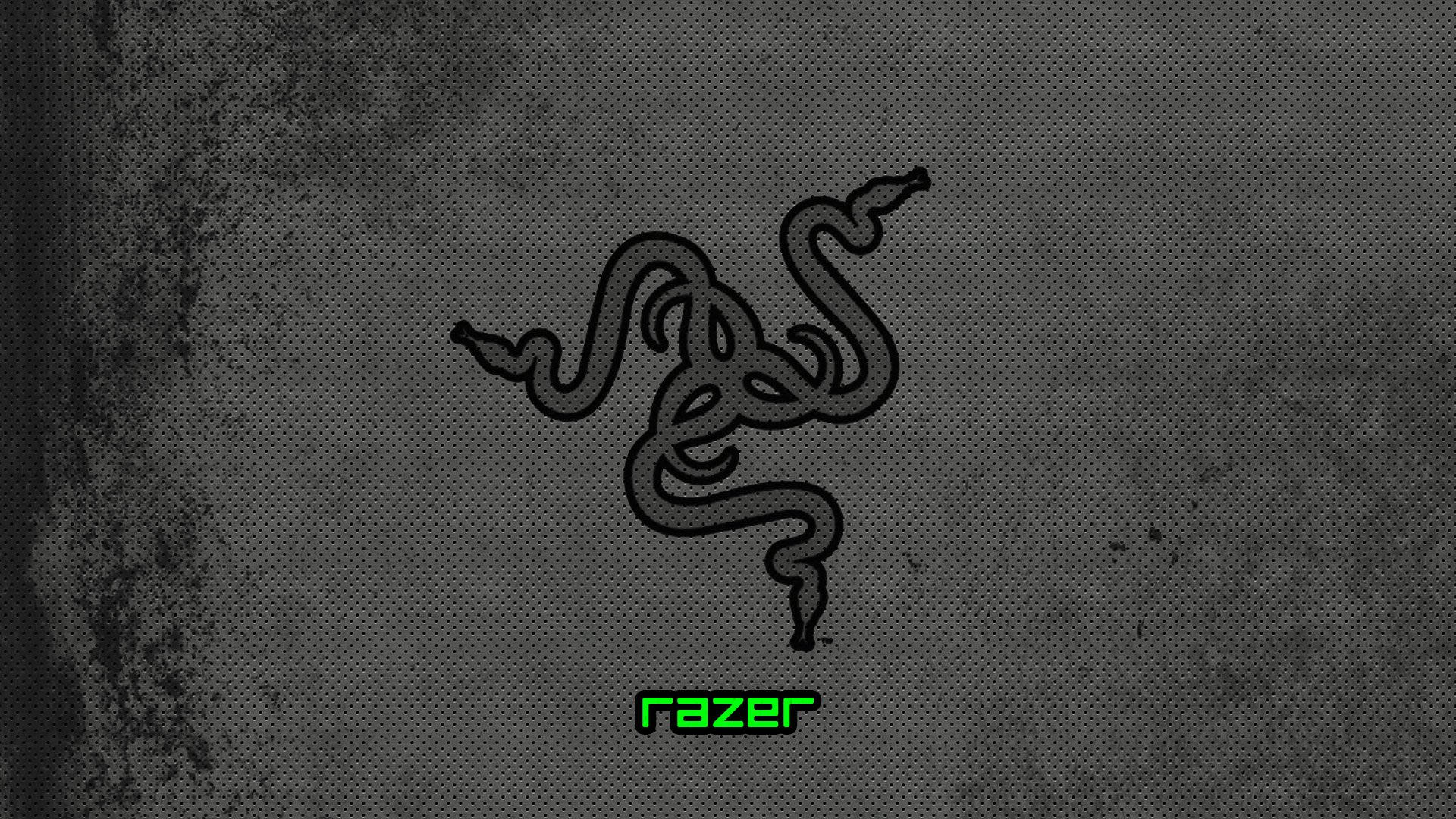 Razer Pc 桌布 壁紙 — 一個黑色Razer標誌，帶有發光綠色文字，位於帶有細微磨損效果的紋理深灰色背景上。