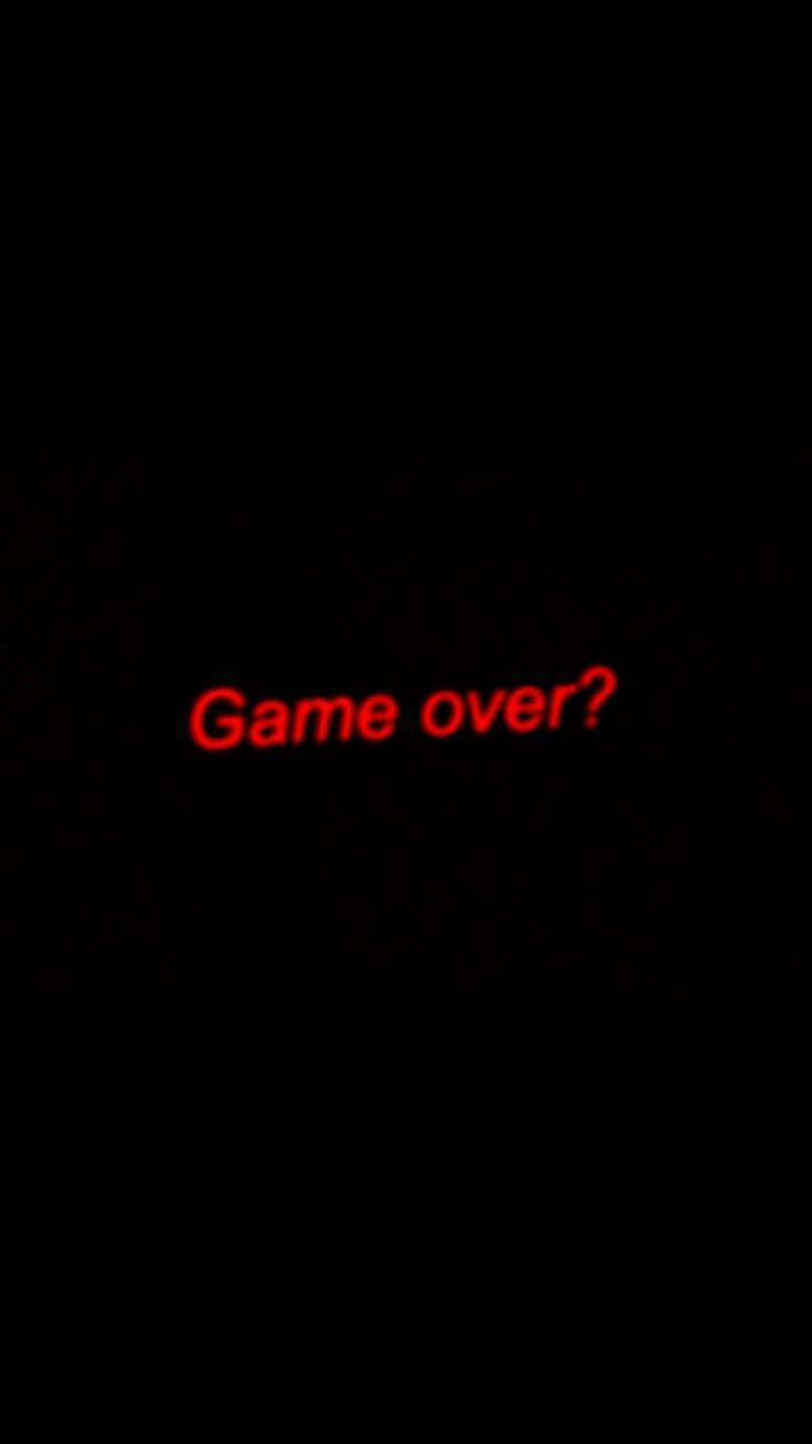 Dark Game Over 桌布 壁紙 — 一個黑色螢幕，帶有發光的紅色文字，以復古電玩字體問「Game over？」。