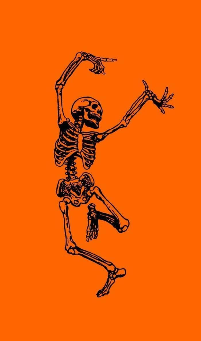 Orange Halloween 桌布 壁紙 — 一個黑色輪廓的骷髏在純橙色背景上充滿活力地跳舞。