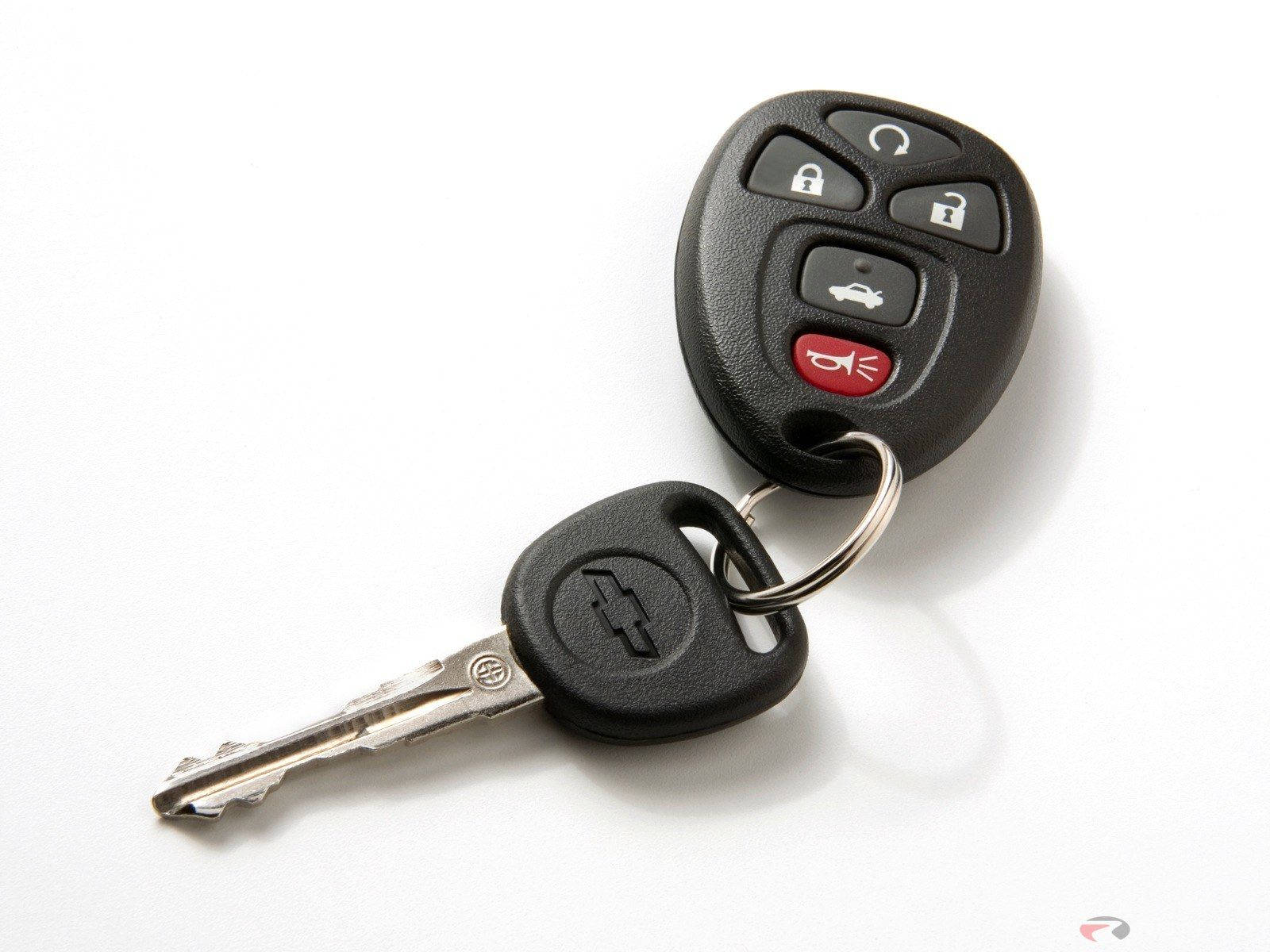 key 桌布 壁紙 — 一個黑色雪佛蘭汽車鑰匙遙控器，帶有遙控按鈕和金屬鑰匙，背景為白色。