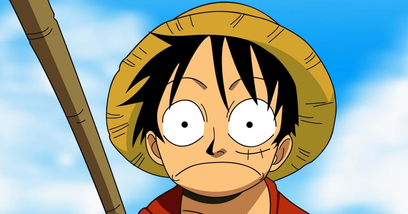 魯夫 桌布 壁紙 — 一個黑髮戴草帽的動漫男孩，眼神堅定地凝視著明亮的藍天。