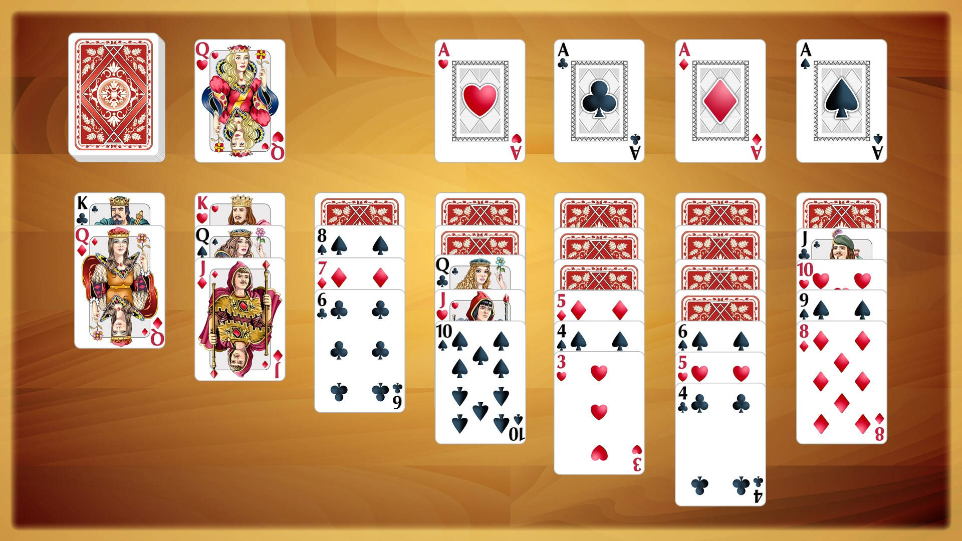 撲克牌以遊戲佈局排列在木質表面上。 — Microsoft 壁紙