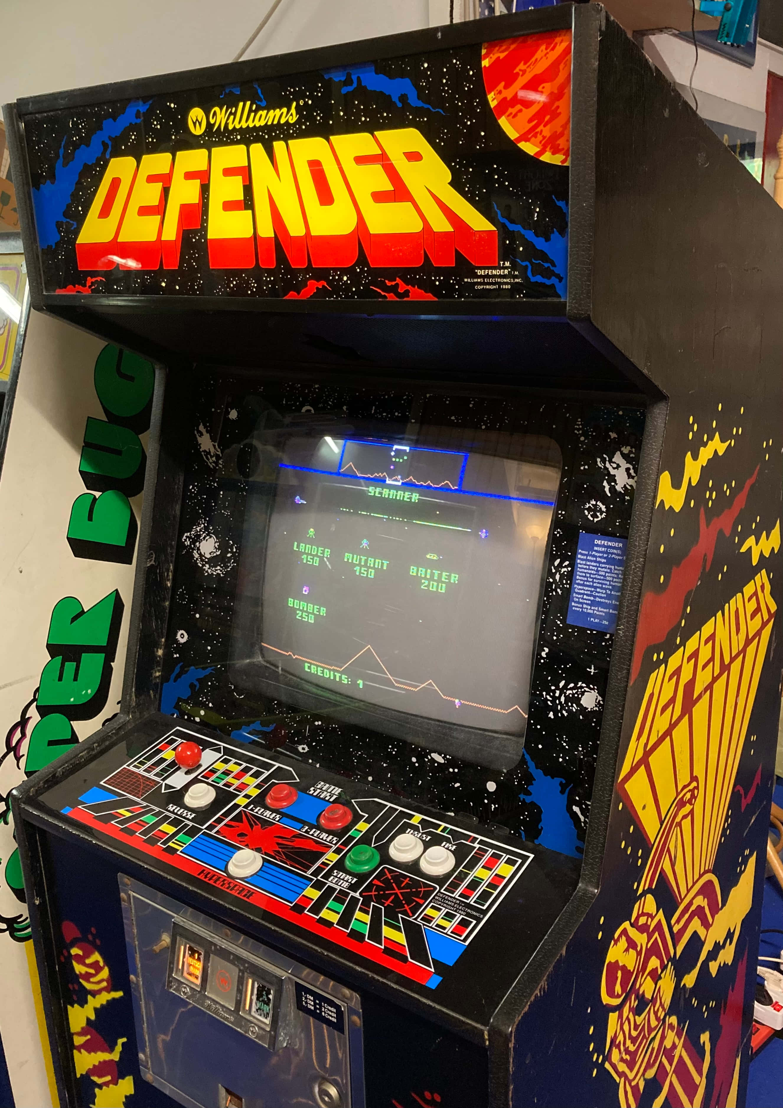 Arcade Games 桌布 壁紙 — 一台復古Williams Defender街機，帶有發光螢幕和色彩繽紛的控制面板。