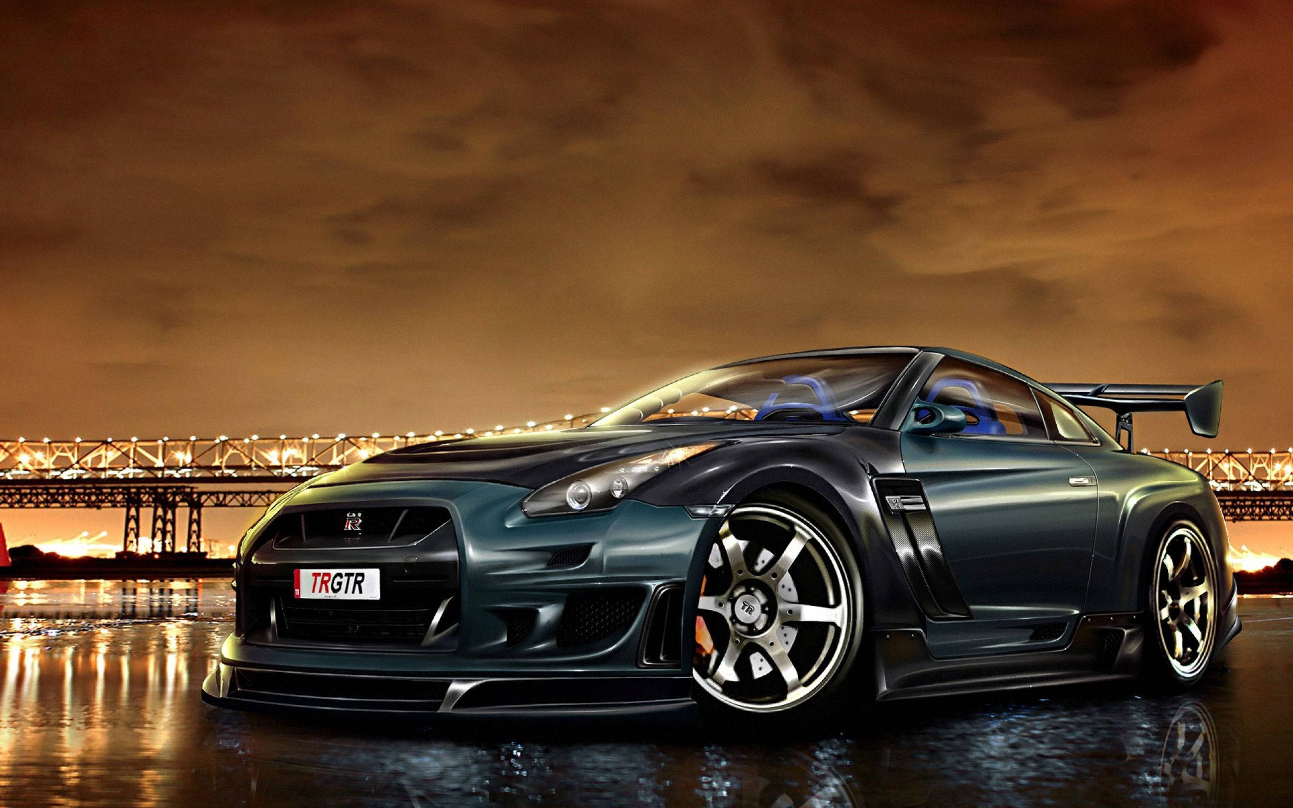 Nissan 桌布 壁紙 — 一台時尚的深藍色日產GT-R跑車在溫暖的夜燈下閃耀，旁邊是反射著燈光的水道，背景有一座橋。