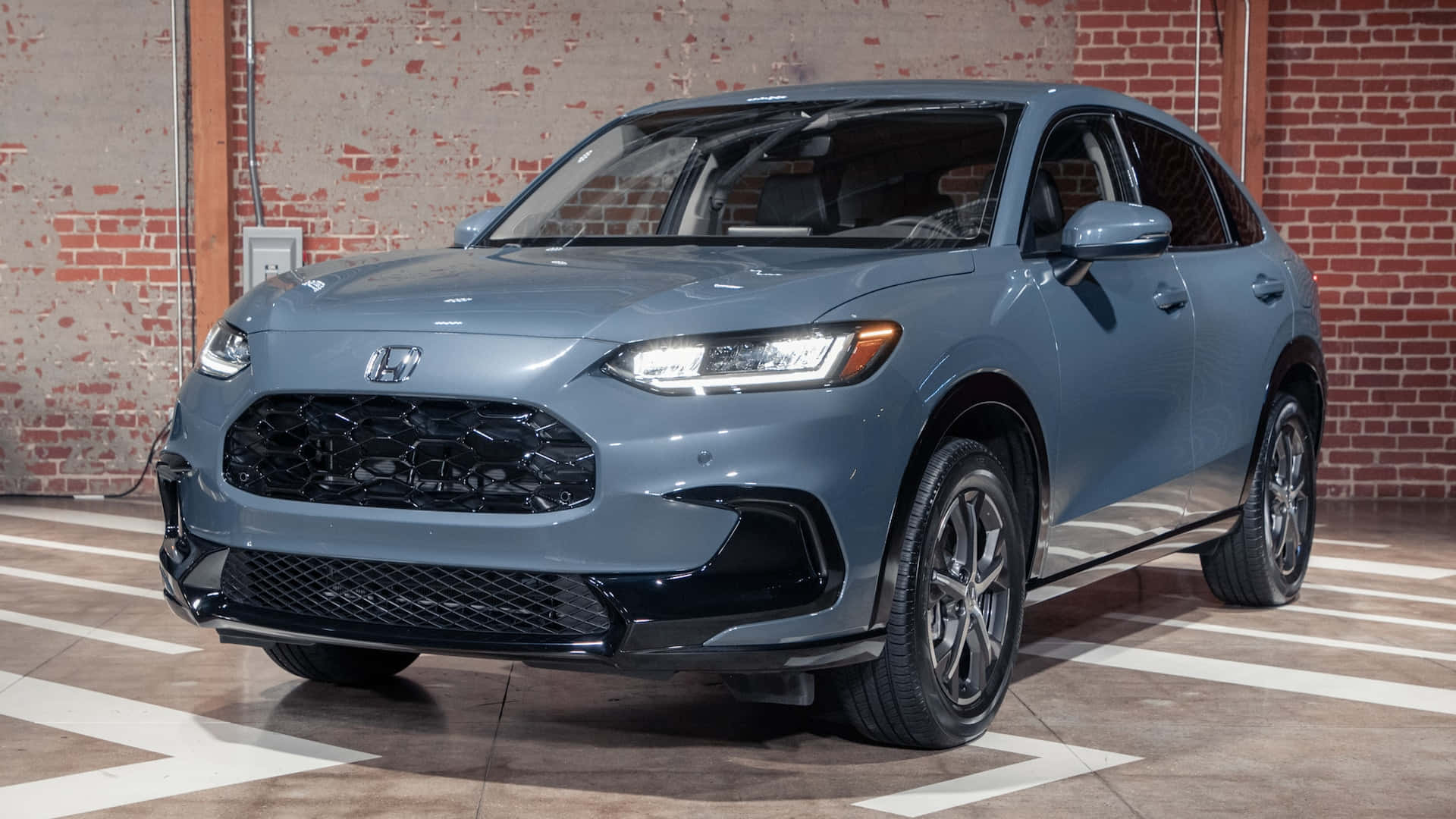 Honda Hr-v 桌布 壁紙 — 一台時尚的灰色本田SUV停放在室內，靠著一面風化的磚牆，地面有白色標記。