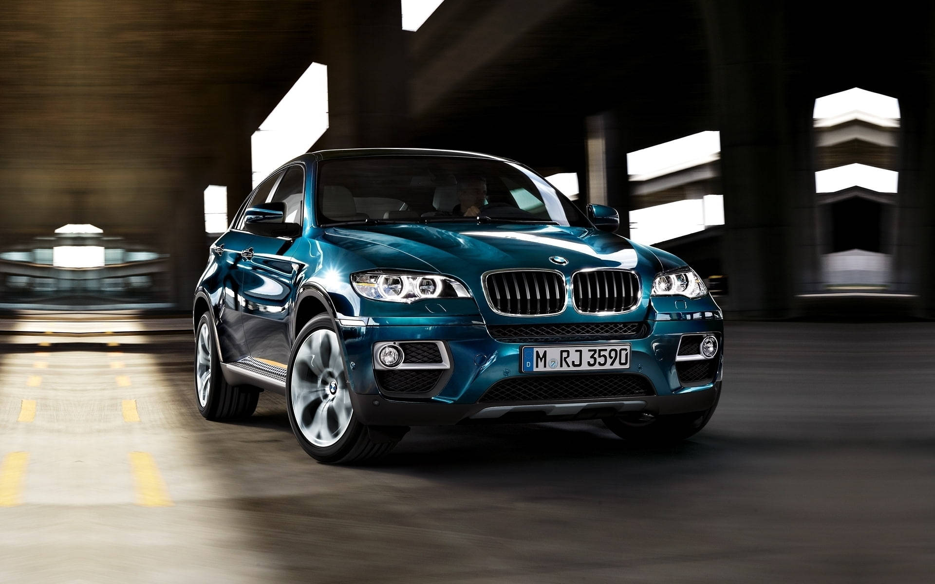 m 桌布 壁紙 — 一台時尚的藍綠色BMW X6在現代隧道中疾馳，動態模糊效果凸顯其動感設計。
