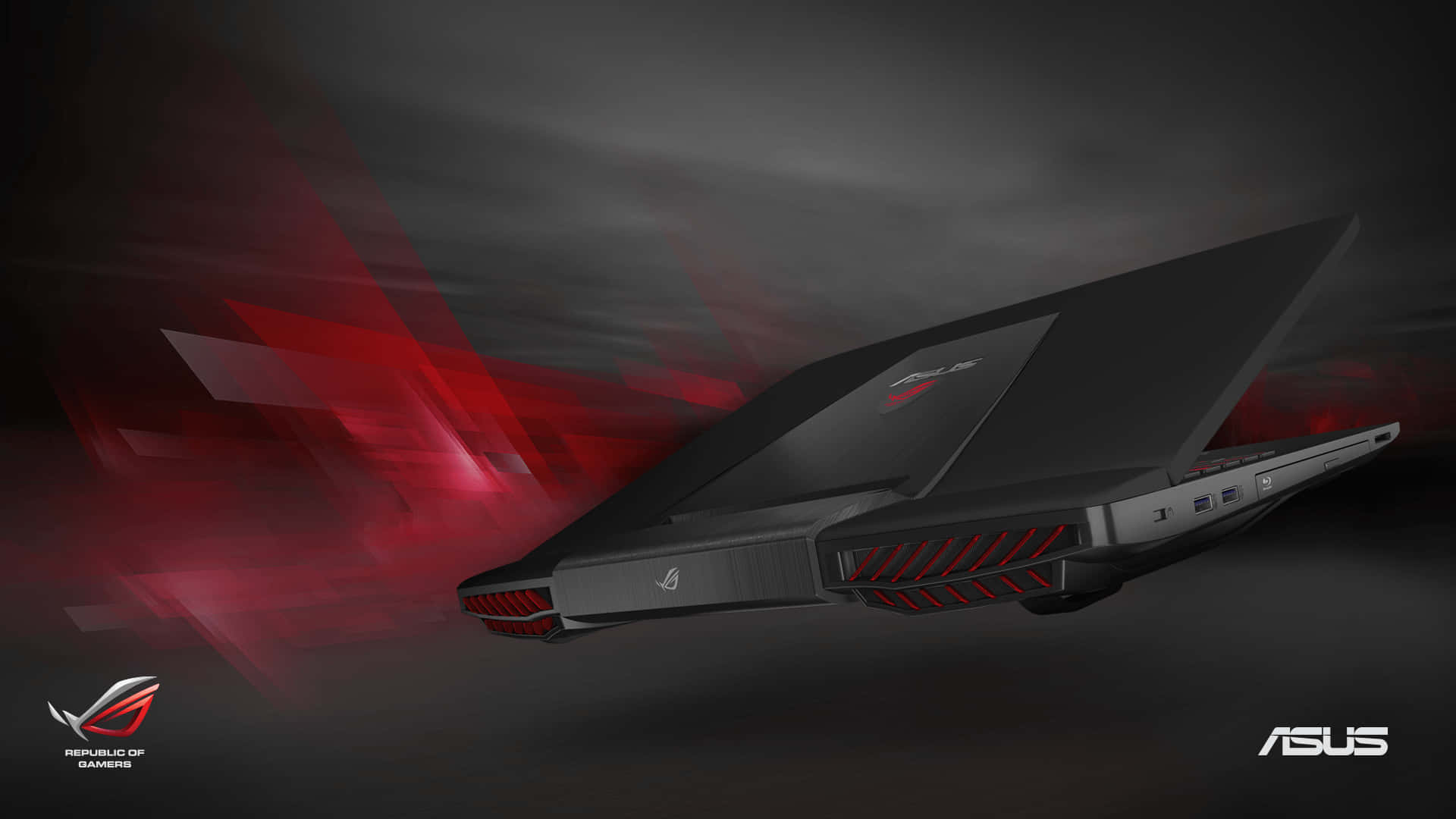 華碩 ROG 桌布 壁紙 — 一台時尚的黑色ASUS ROG電競筆記型電腦，帶有紅色點綴，在黑暗的抽象空間中滑行，留下發光的紅色動態軌跡。