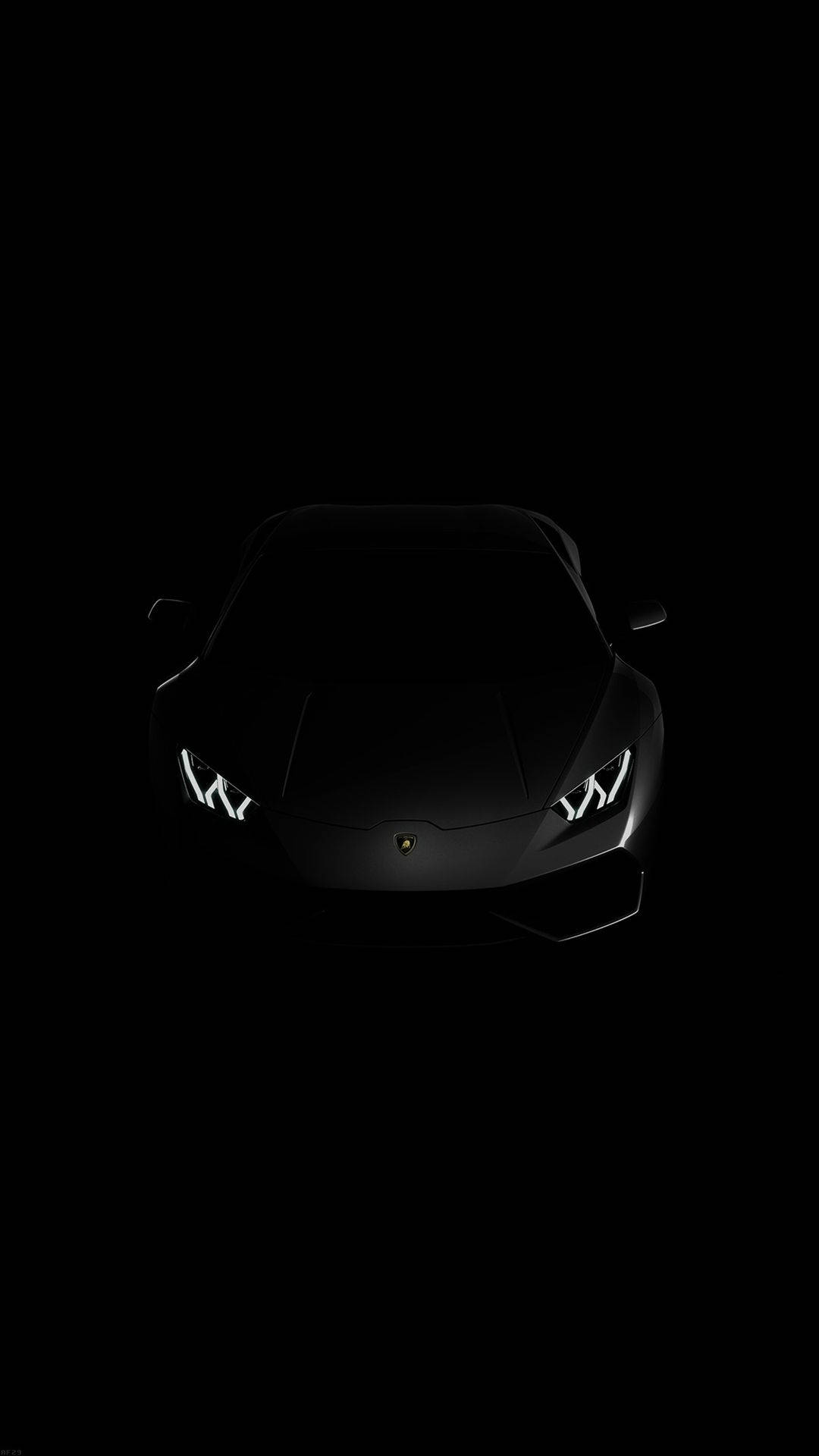 elegant 桌布 壁紙 — 一台時尚的黑色藍寶堅尼跑車在漆黑一片的虛空中閃耀著亮起的車頭燈。