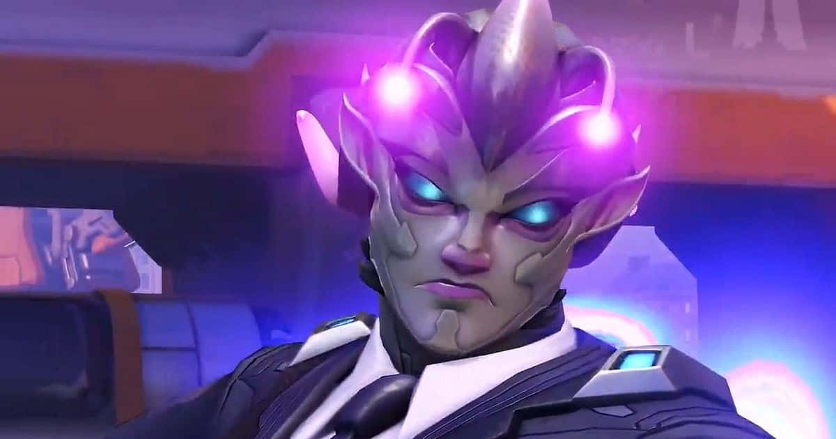 Overwatch Zarya 桌布 壁紙 — 一名兇猛的外星戰士，戴著發光的紫色頭飾和藍色眼睛，在未來風格的駕駛艙內凝視著。