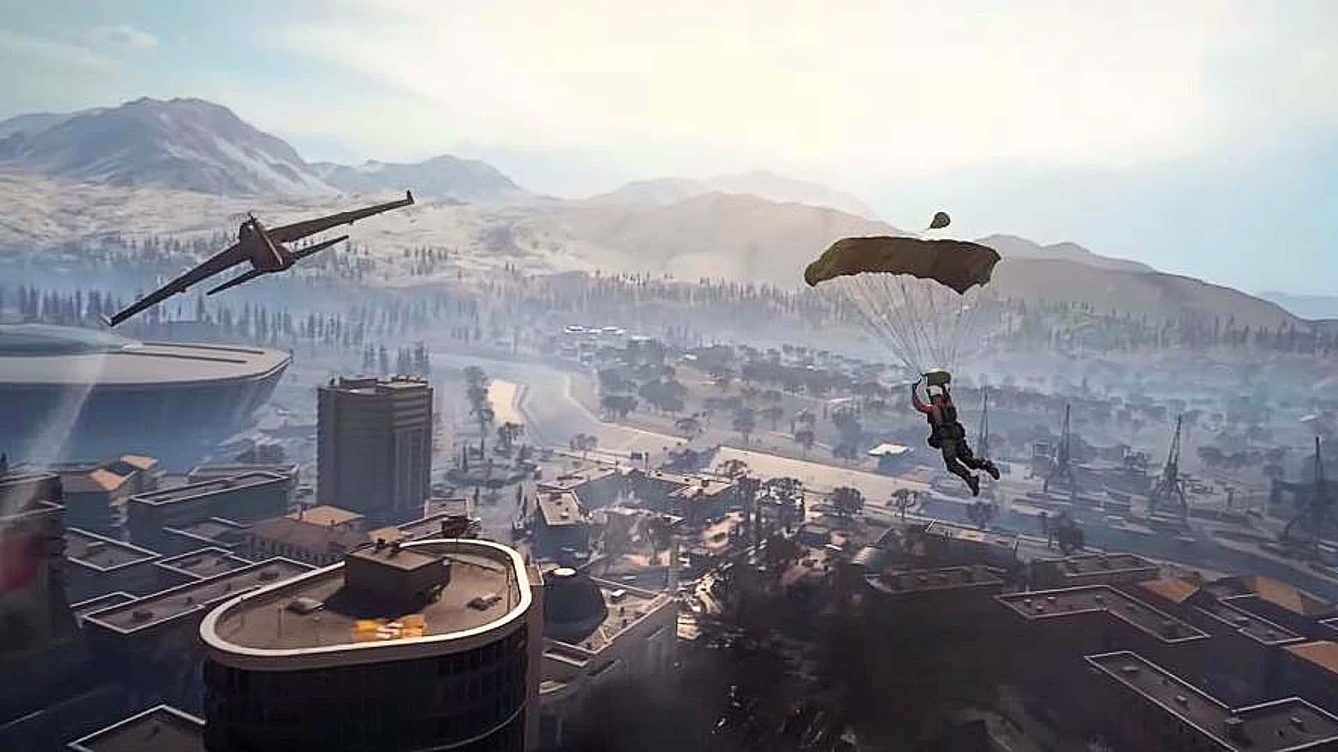 Call Of Duty Battles 桌布 壁紙 — 一名士兵在戰爭摧殘的城市景觀上空跳傘，天空中有雪山和損壞的飛機。