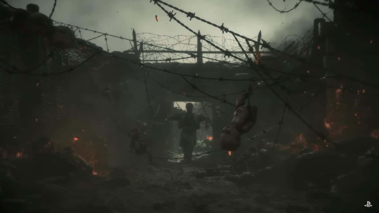 Death Stranding Pc 桌布 壁紙 — 一名士兵在鐵絲網下走過戰火摧殘的戰場，陰暗中有懸掛的屍體和悶燒的火堆。