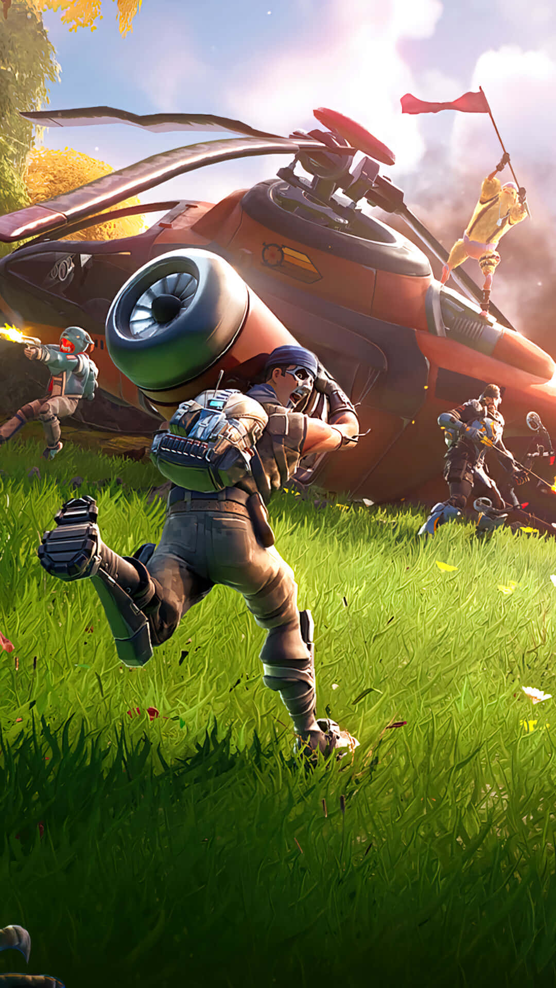 Fortnite iPhone 桌布 壁紙 — 一名士兵在鮮綠色草地上衝刺，身後一架紅色直升機墜毀，隊友們在混亂的戰鬥場景中開火。