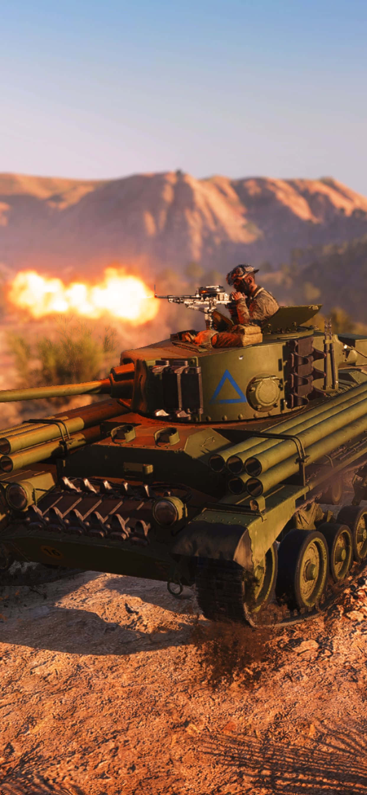 battlefield v iPhone 桌布 壁紙 — 一名士兵從綠色坦克頂部發射機槍，背後在沙漠峽谷中夕陽下發生爆炸。