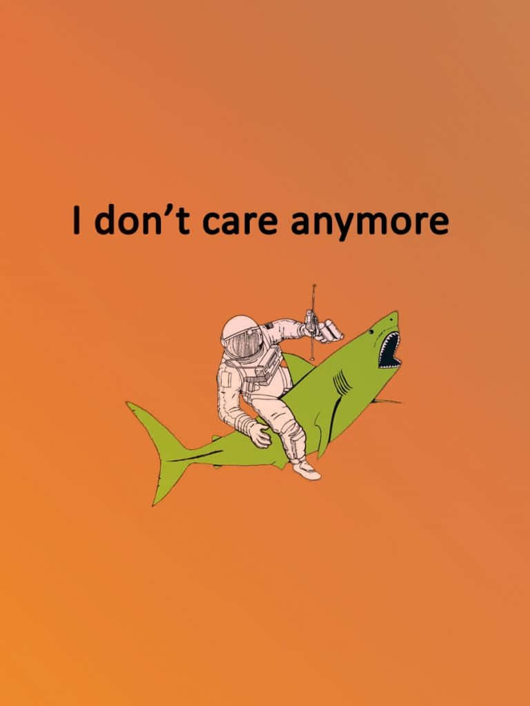 Dont Care 桌布 壁紙 — 一名太空人騎著綠色鯊魚，背景為純橙色，並帶有文字「I don't care anymore」。