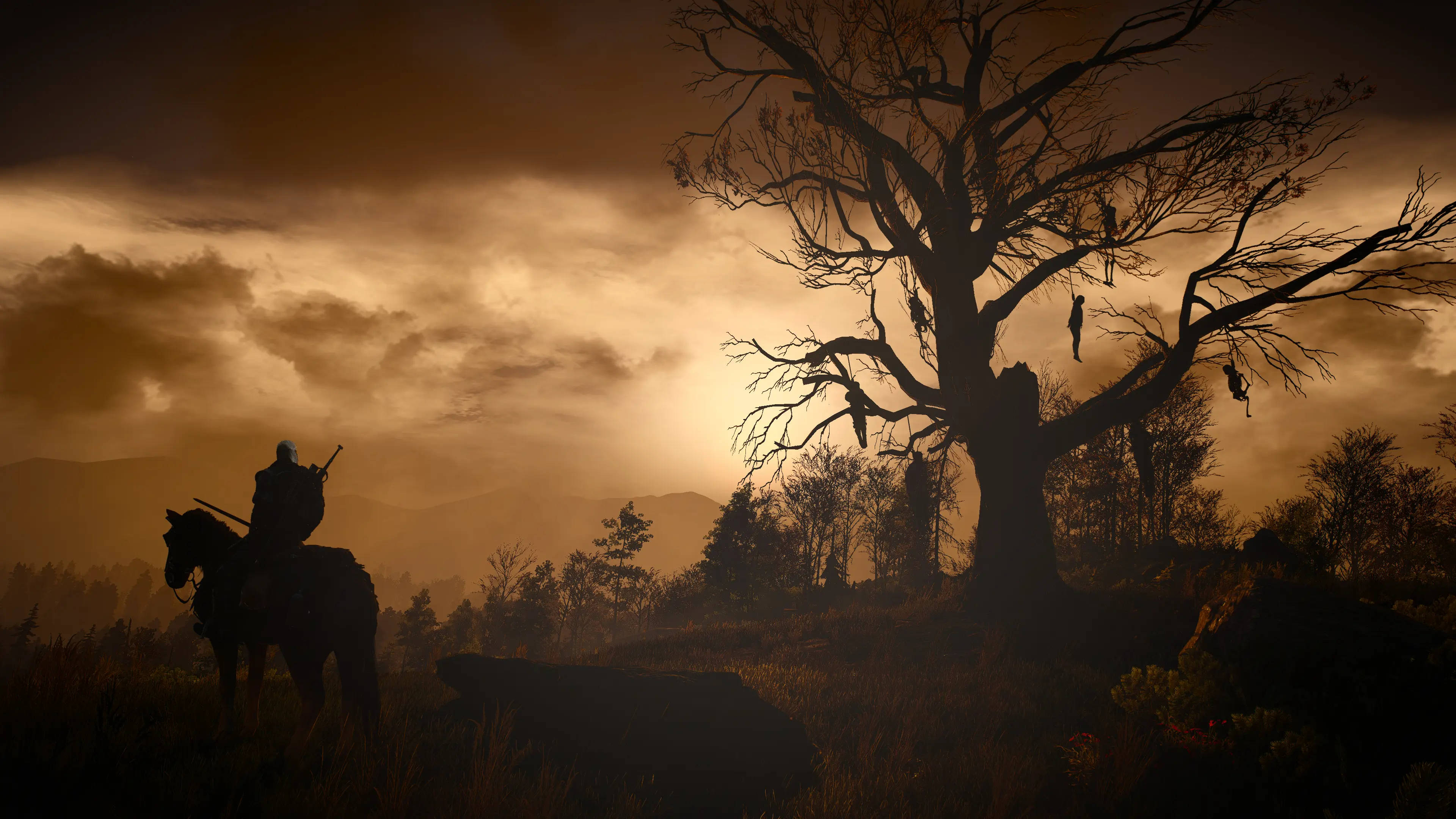 witcher 4K 桌布 壁紙 — 一名孤獨的騎士騎著馬，經過一棵掛著屍體的巨大光禿樹木，背景是金色的黃昏天空。