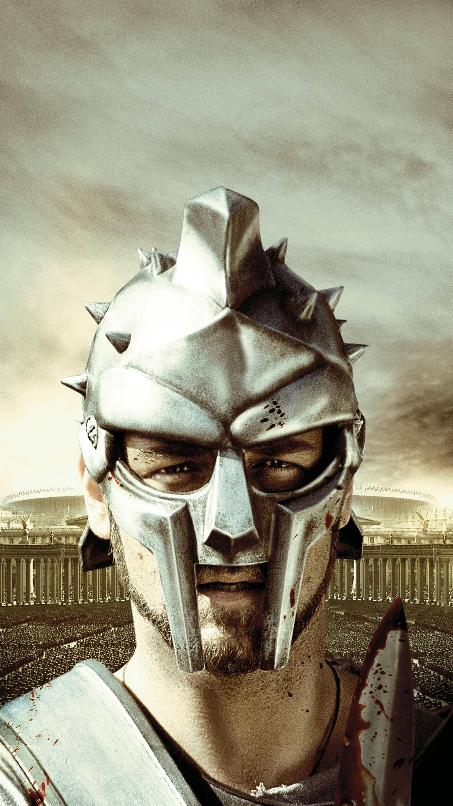 Gladiator 桌布 壁紙 — 一名戴著尖刺頭盔的斯巴達戰士在暴風雨的天空下，從古羅馬競技場中凝視著。