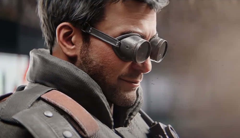 Rainbow Six Siege Thermite 桌布 壁紙 — 一名戴著護目鏡和戰術裝備的男子，以堅定的表情凝視遠方的特寫。