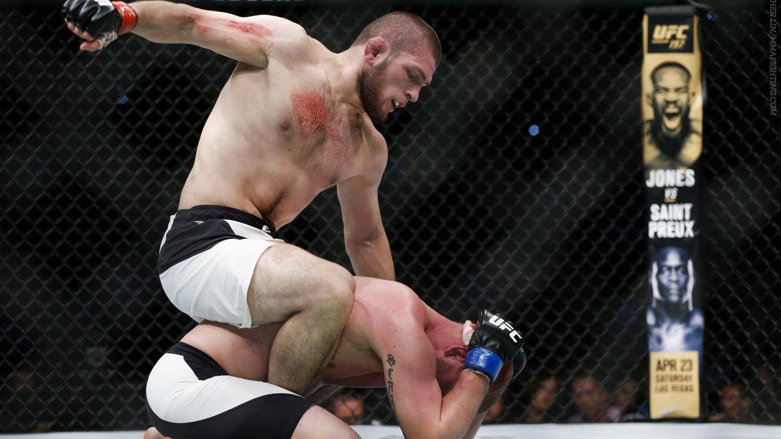UFC 桌布 壁紙 — 一名拳手在UFC八角籠內進行激烈的綜合格鬥比賽時，向對手發出強力一擊。