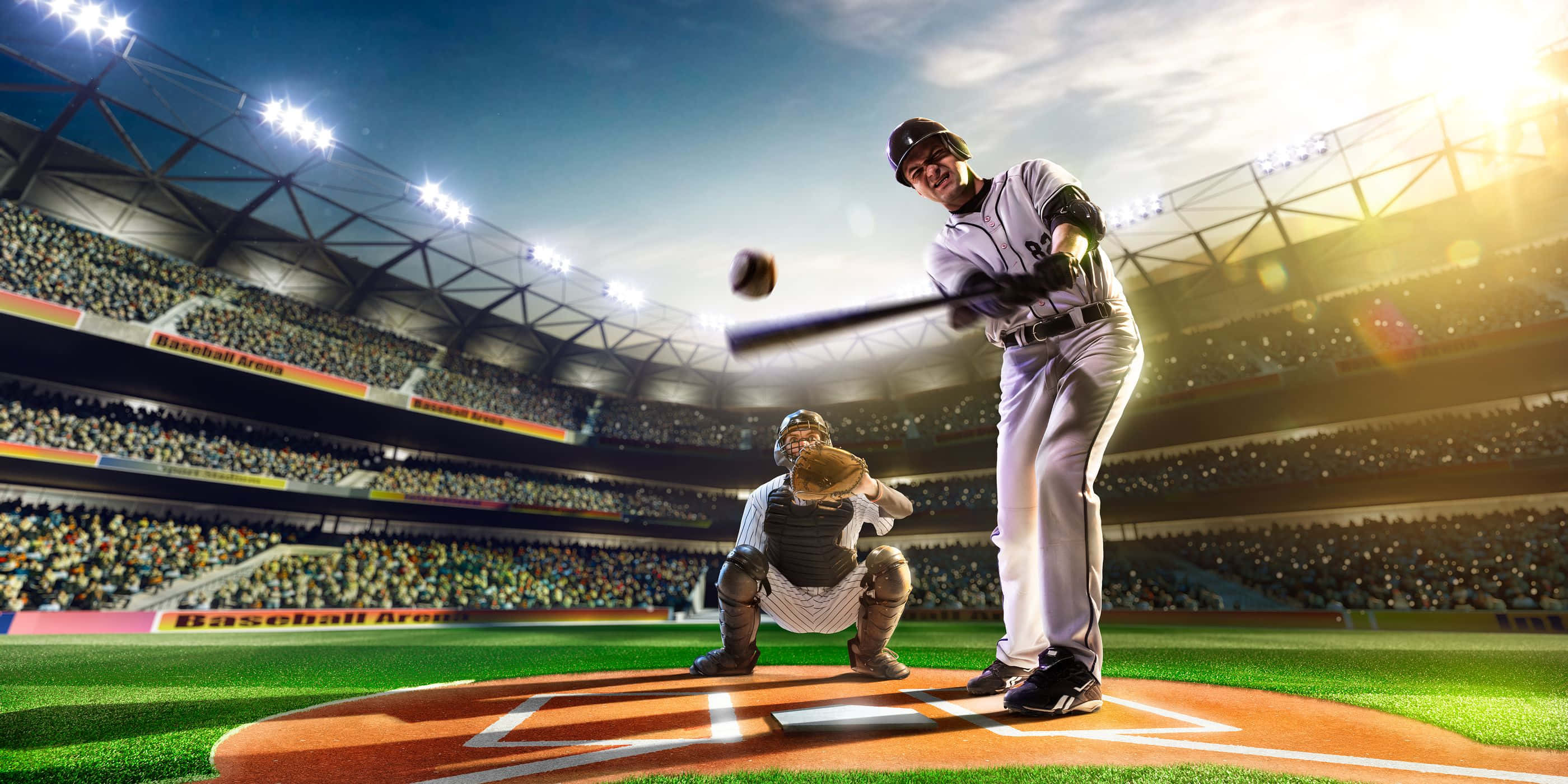Baseball Stadium 桌布 壁紙 — 一名棒球選手在球場燈光下揮棒擊球，捕手蹲在本壘板後方。